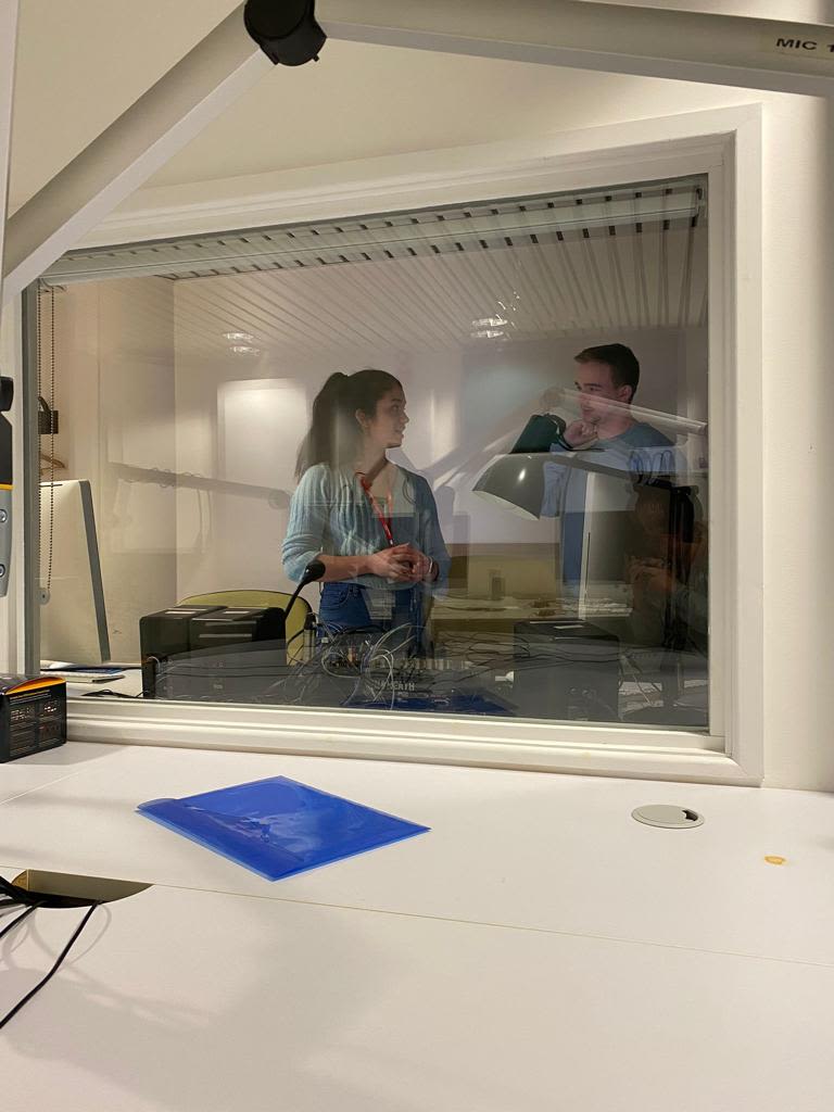 Salina talking to colleague in studio