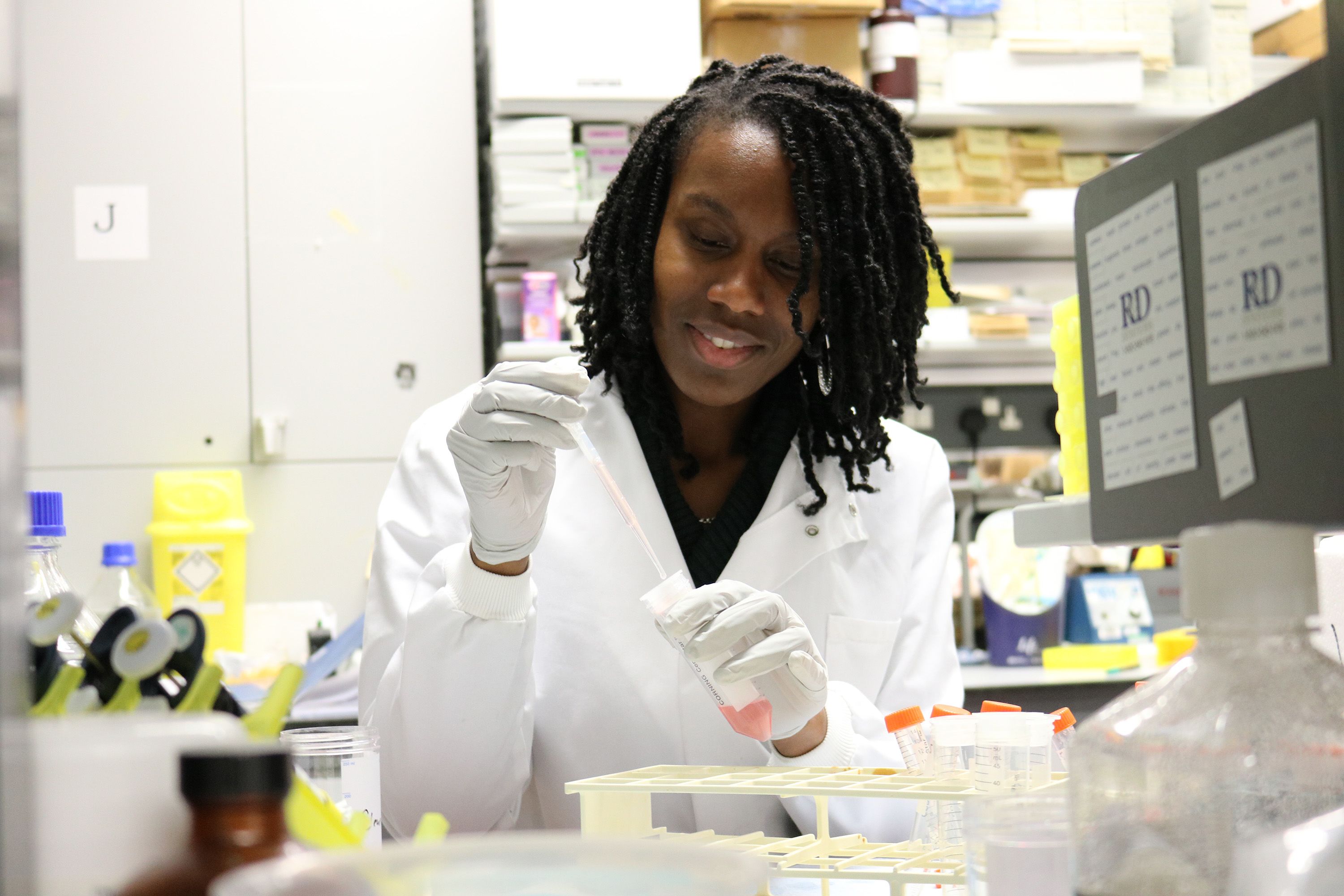 Simone uses pipette in lab