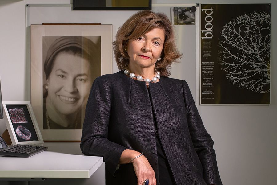 Anna Randi leans against desk