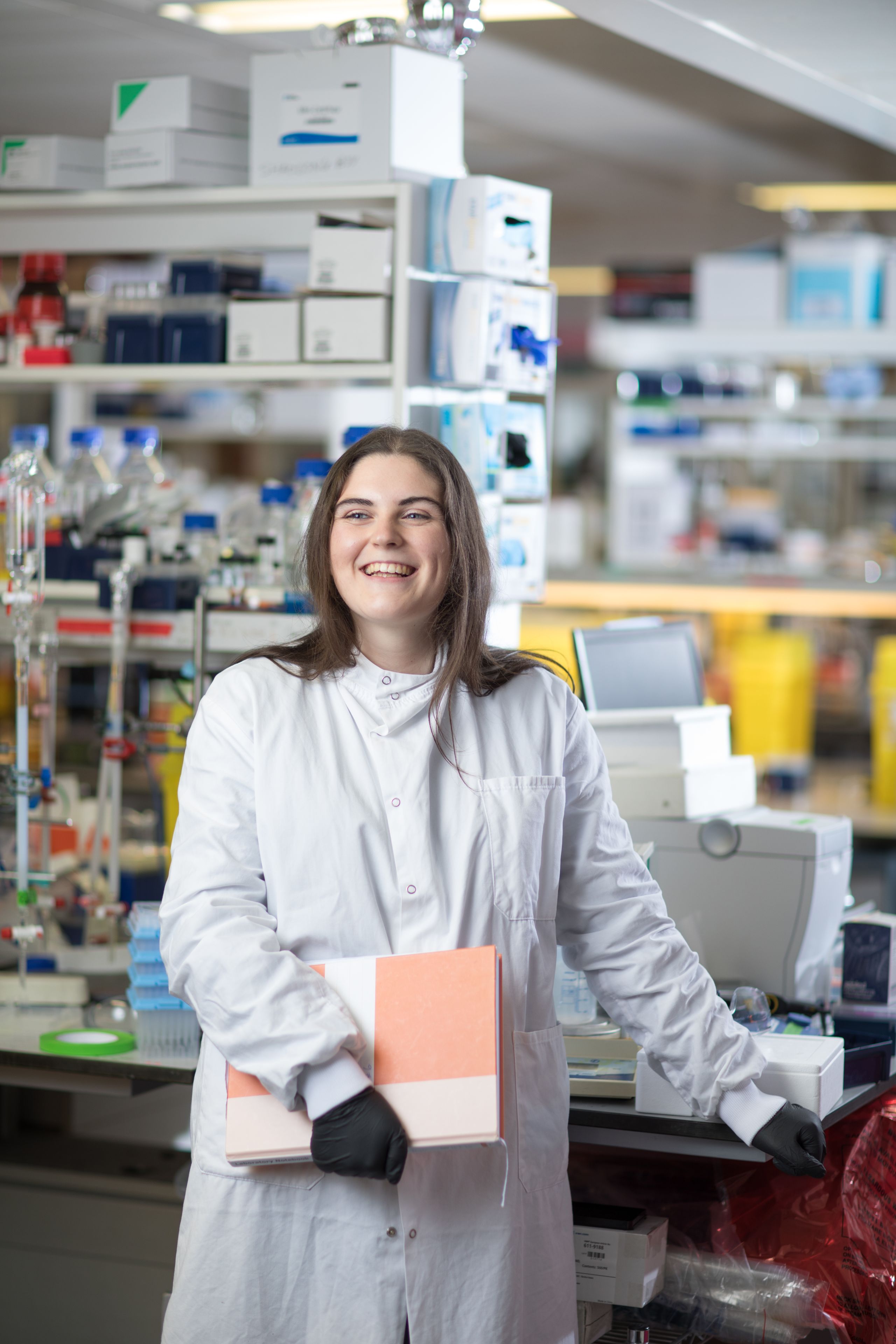 Leah (molecular bioengineering) smiling in a lab.