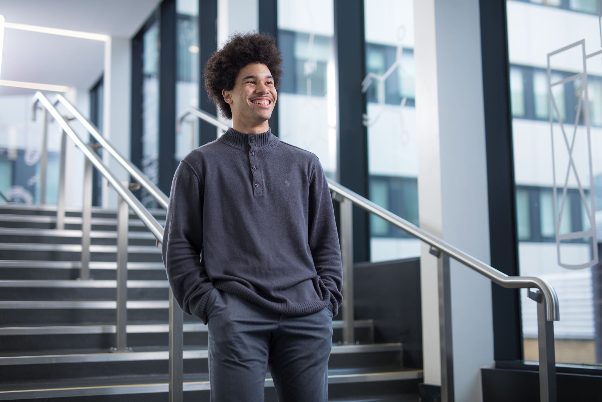 Karl (electronic and information engineering) smiling on a set of stairs.