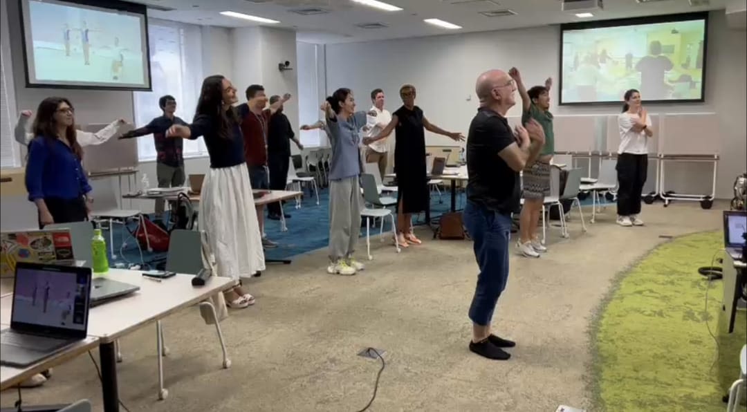 GID students taking a stretching break during a dinner in Tokyo at Keio University