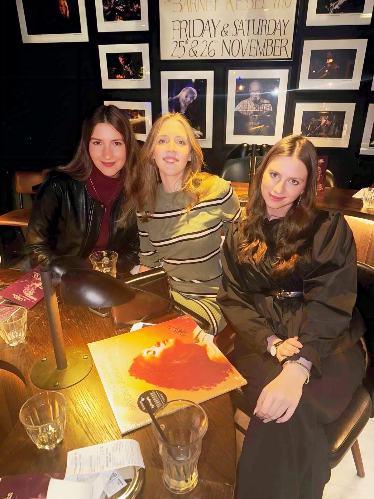 Alexandra with two friends sitting at a table during an event in London