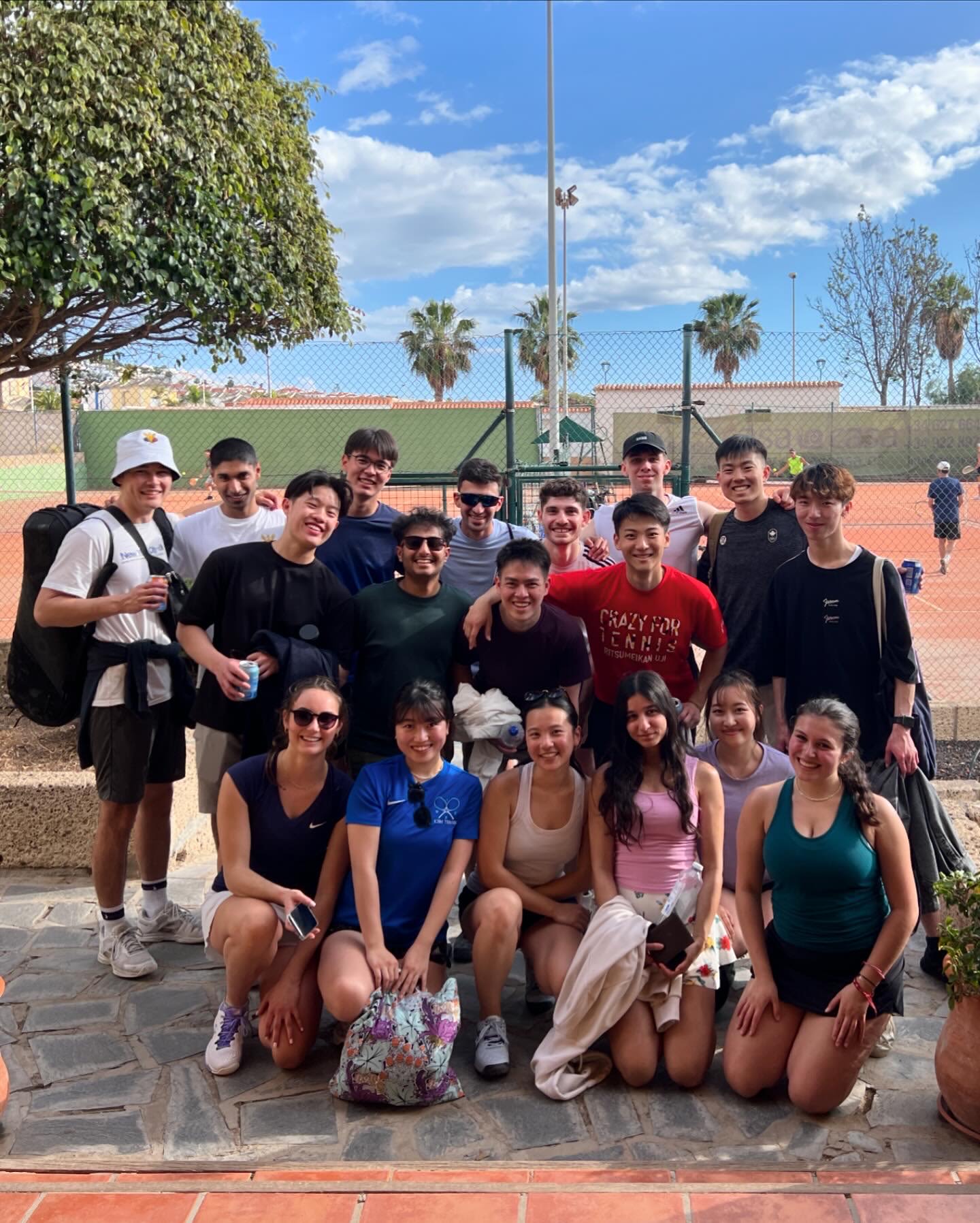 Group photo of Andrew and the Imperial Medics varsity team outside tennis courts in Tenerife