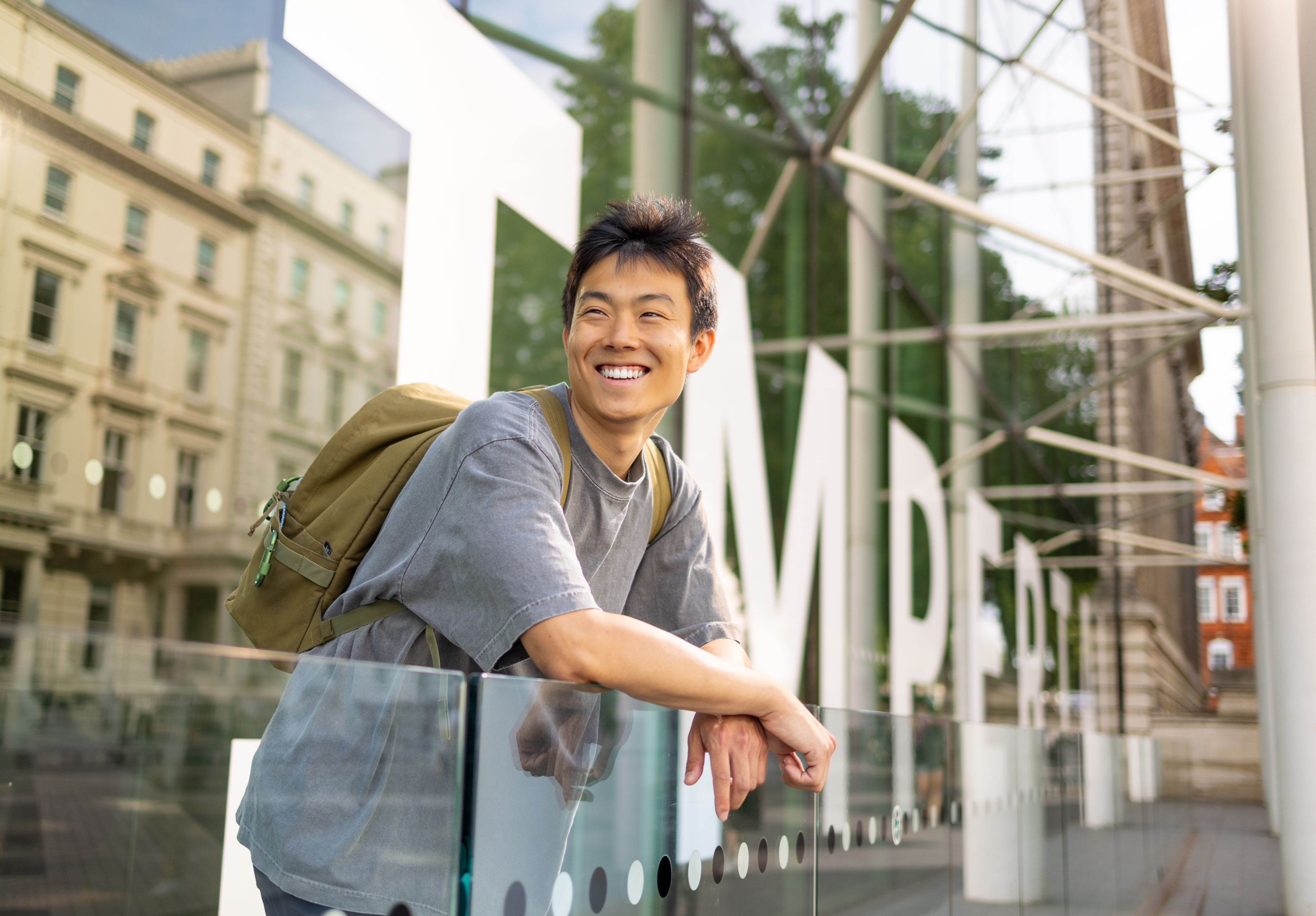 Andrew outside the main entrance of South Kensington Campus with the Imperial logo behind him