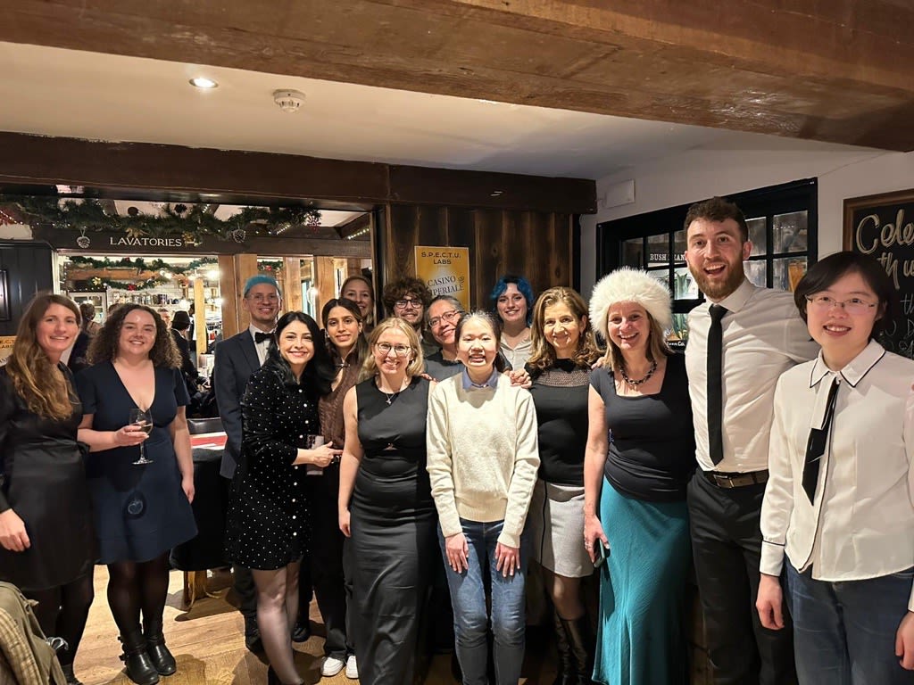 Group photo of Annie and her colleagues inside a pub