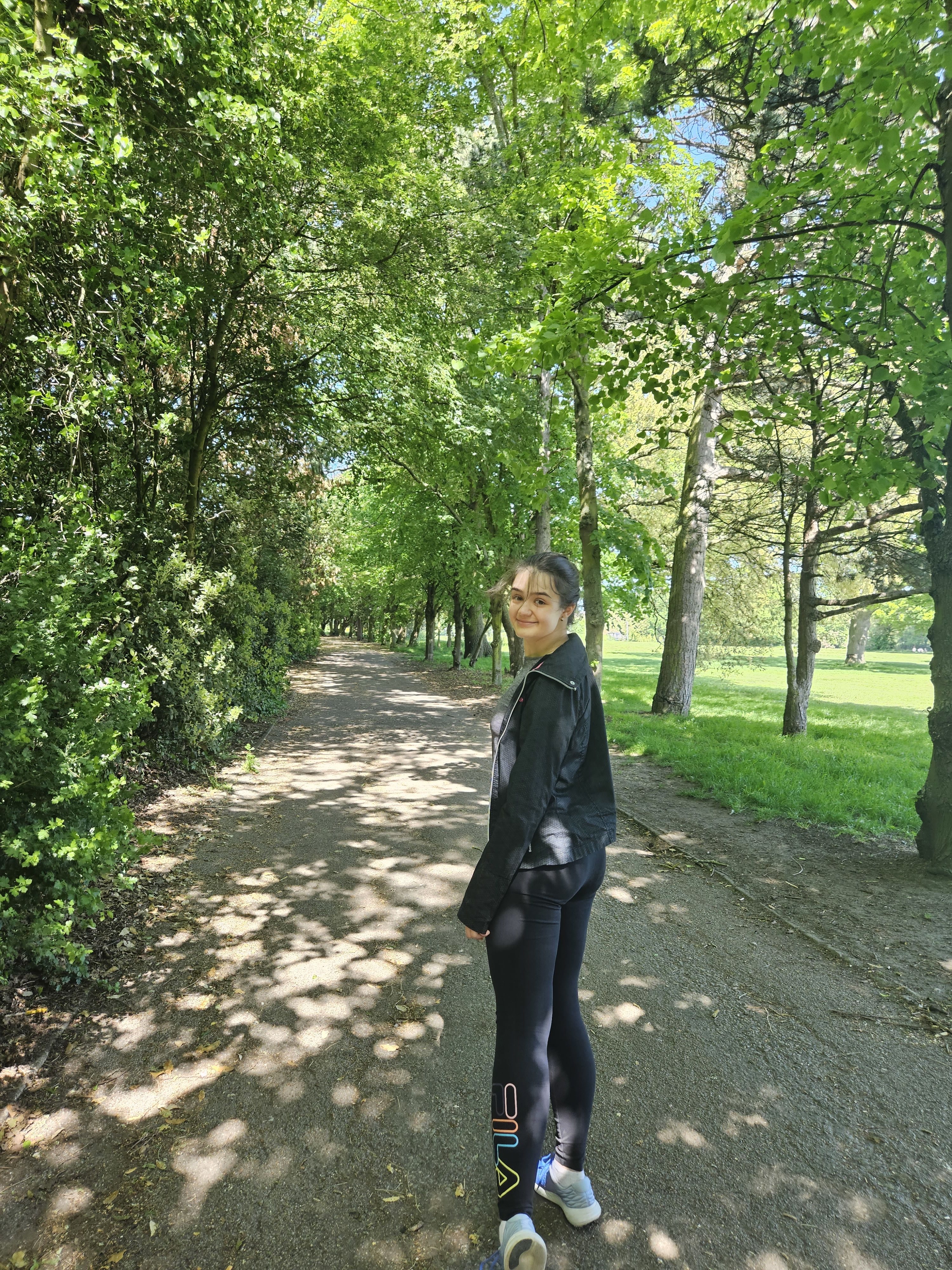 Cristiana walking through a park 