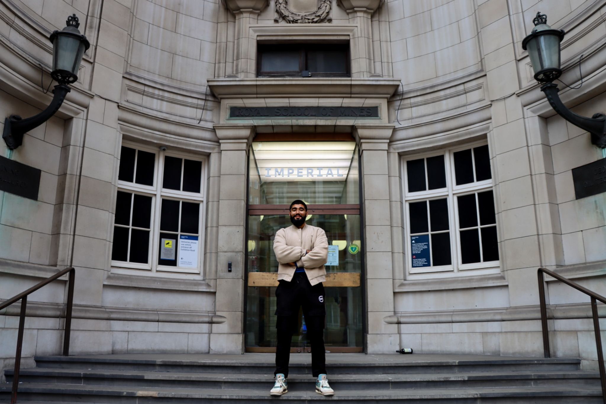 Haaris standing outside an entrance to The Royal School of Mines building