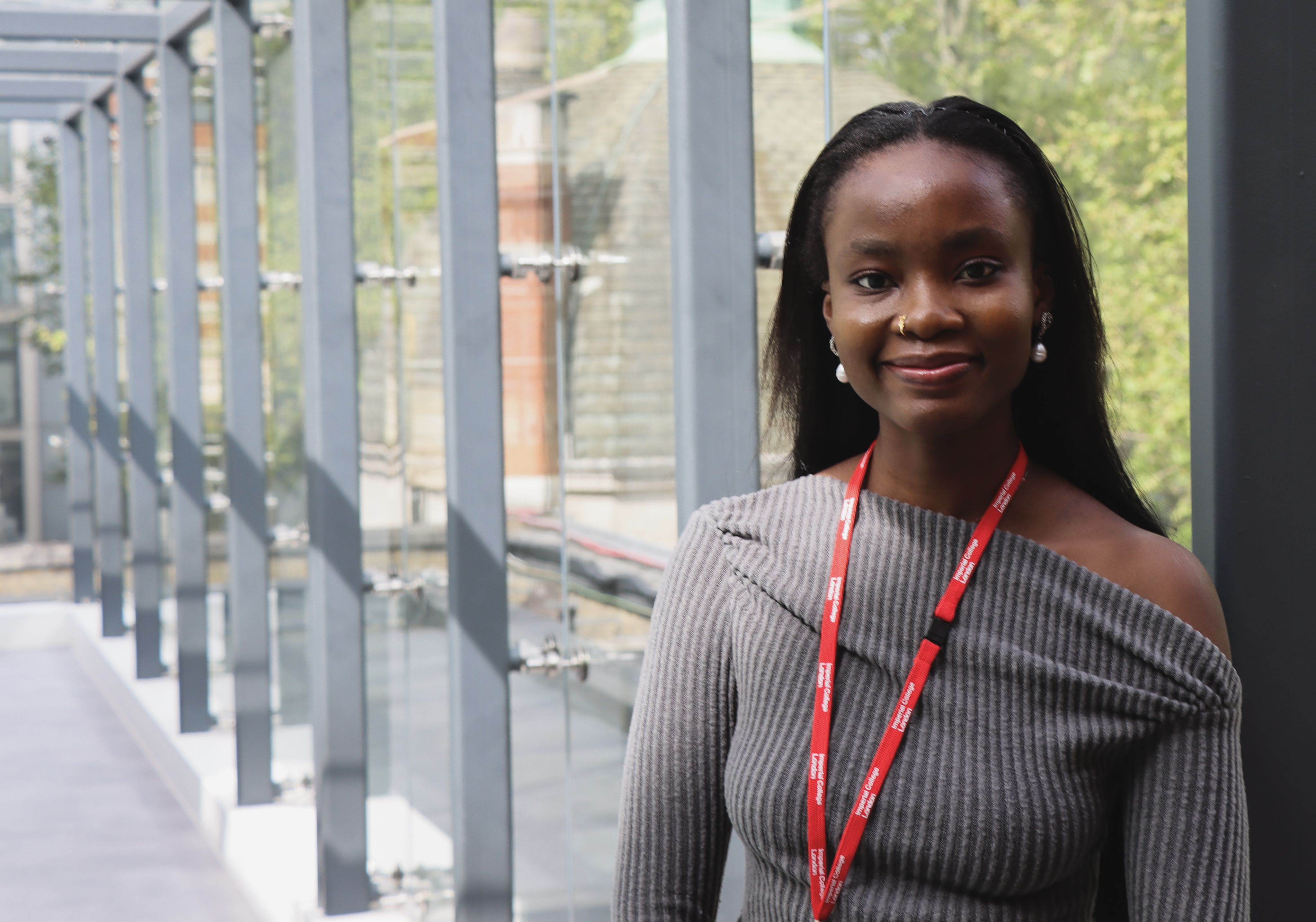 Ifeoluwa standing in a clear window corridor