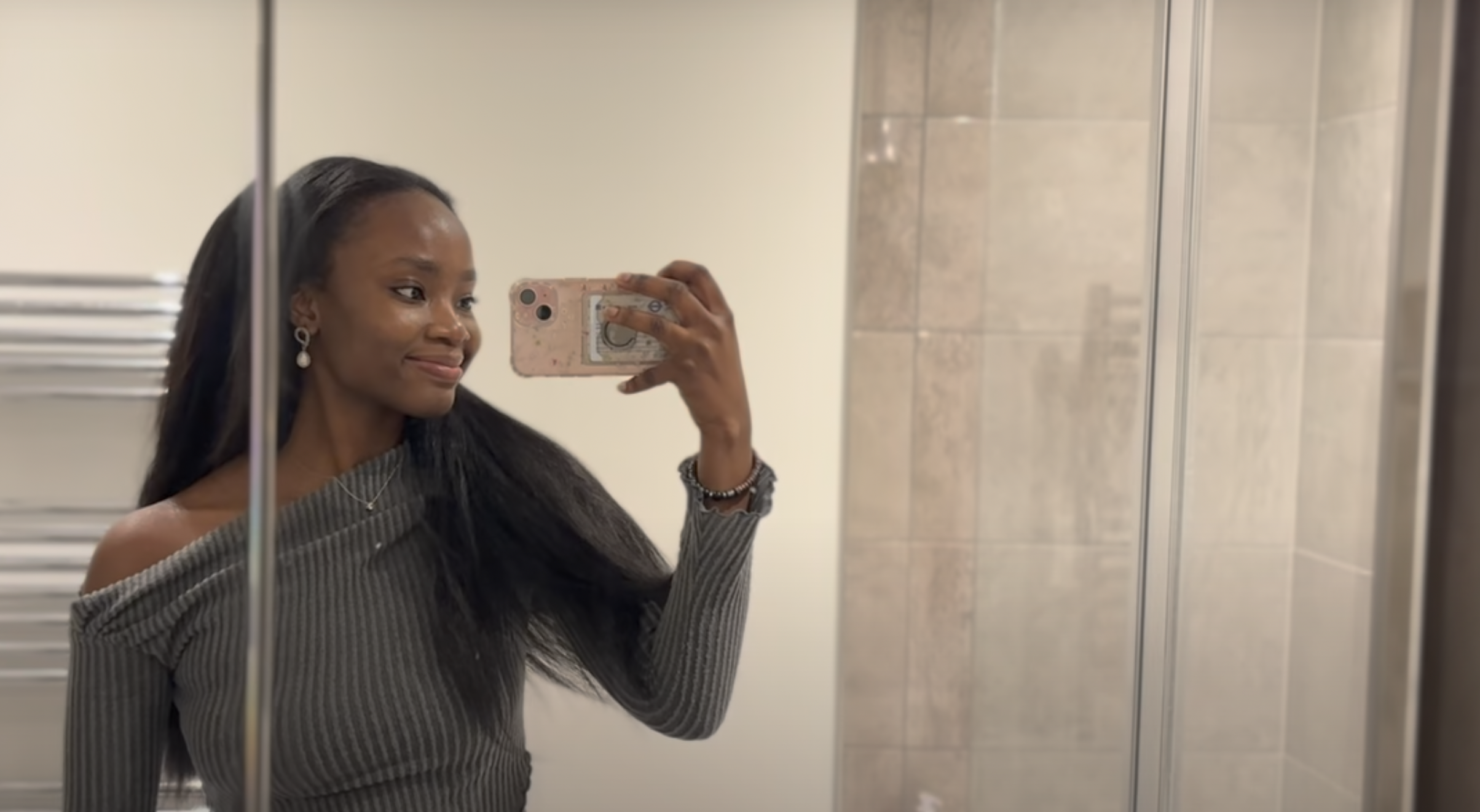 Ifeoluwa filming herself in a bathroom mirror