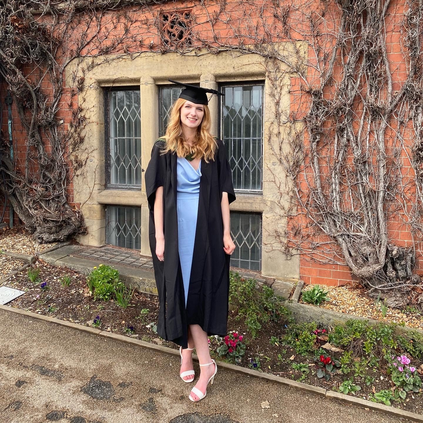 Katie in a graduation gown and cap