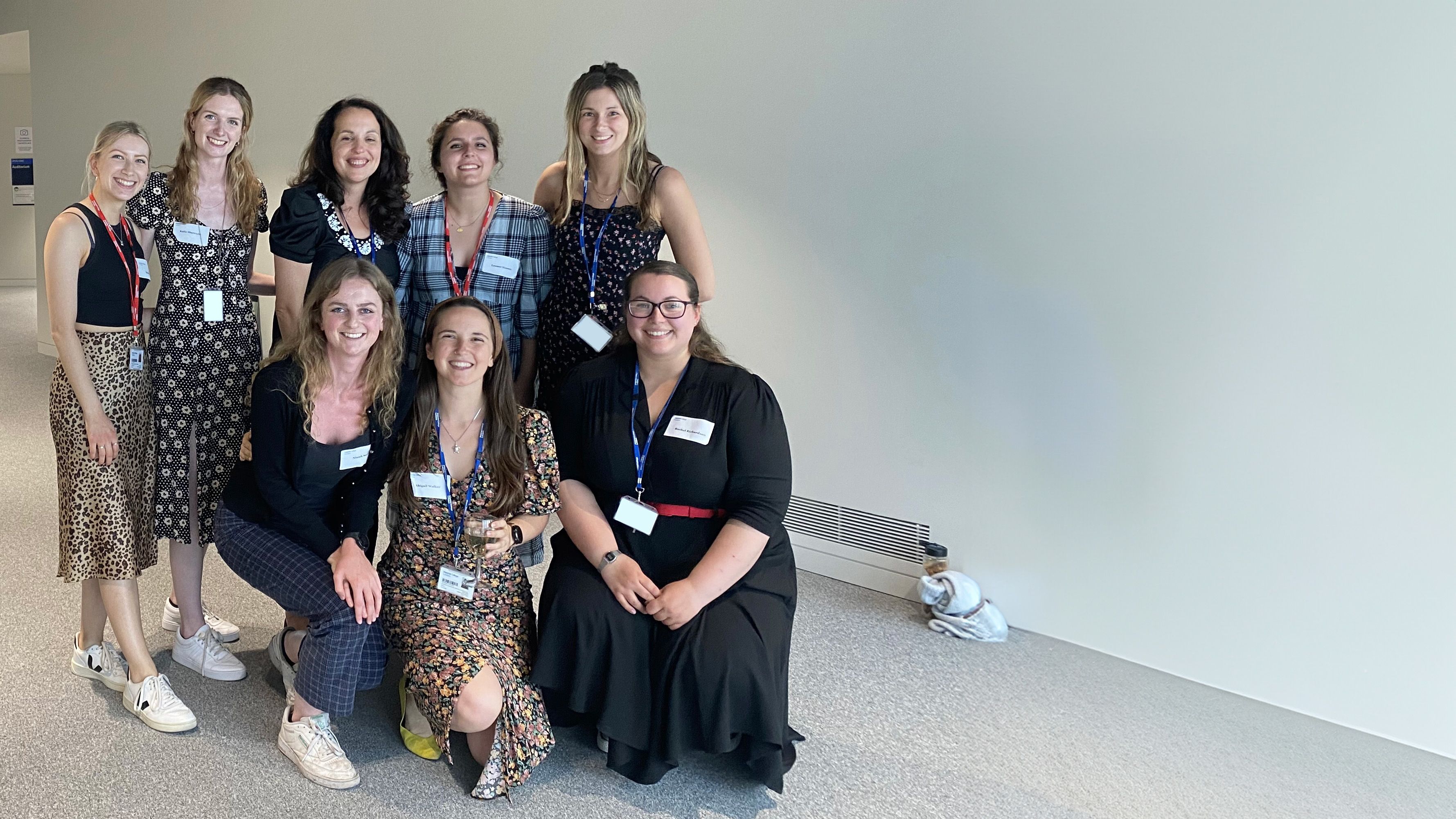 Group photo of Katie and other PhD students at an event