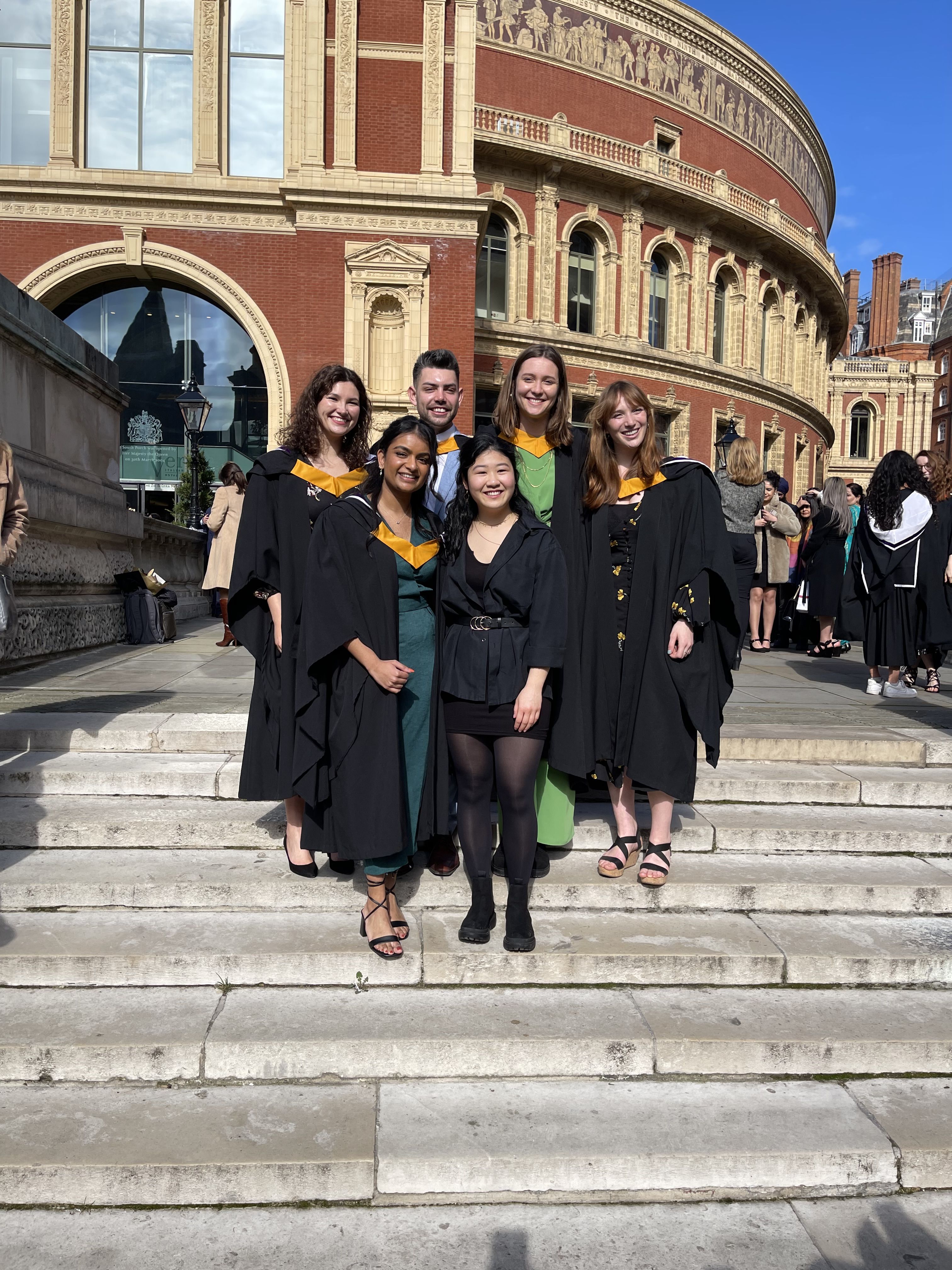 Kyle and friends standing outside the Royal Albert Hall in Bachelor's graduation gowns