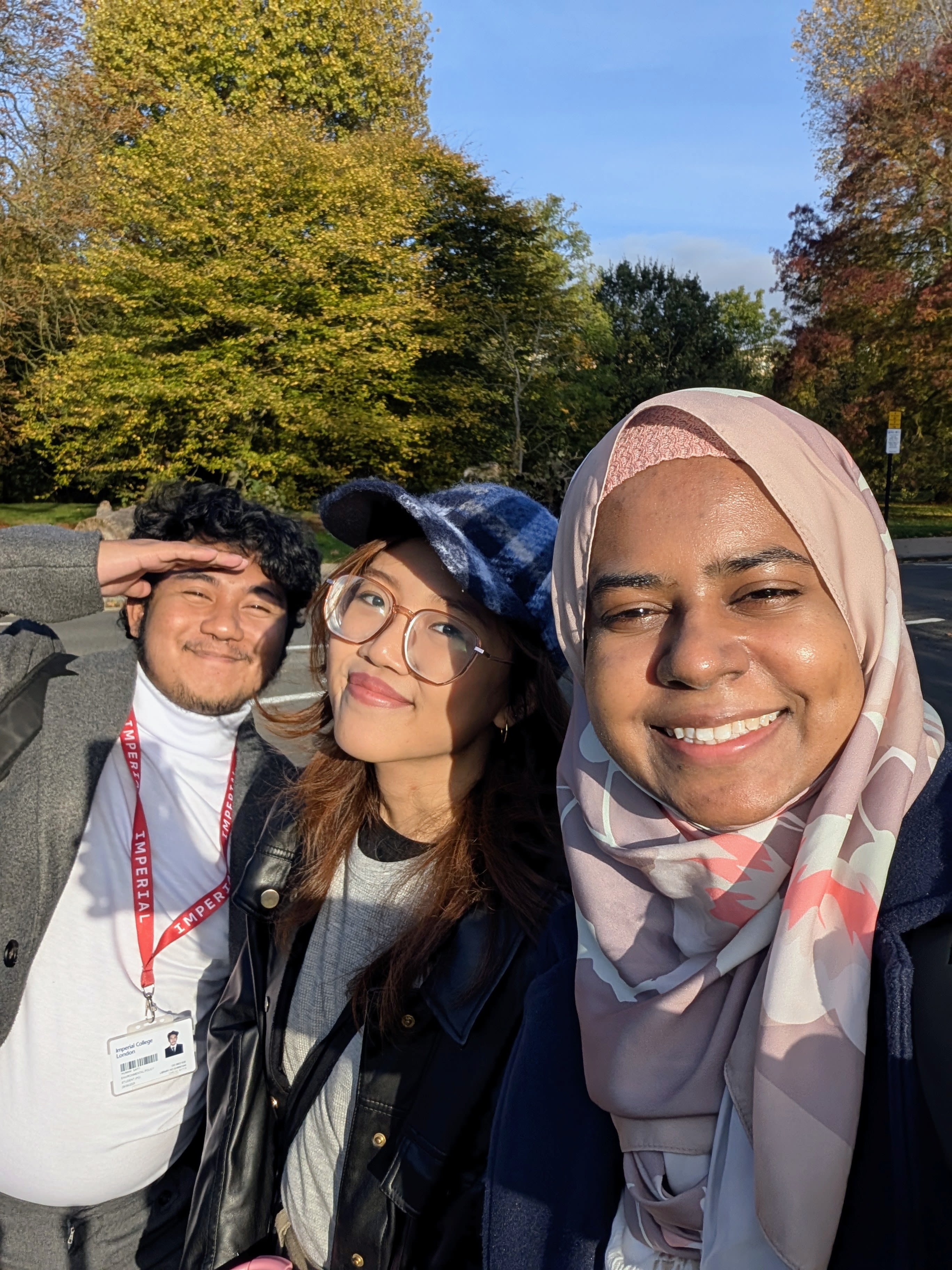 Nafisah taking a selfie with two friends in the sunshine