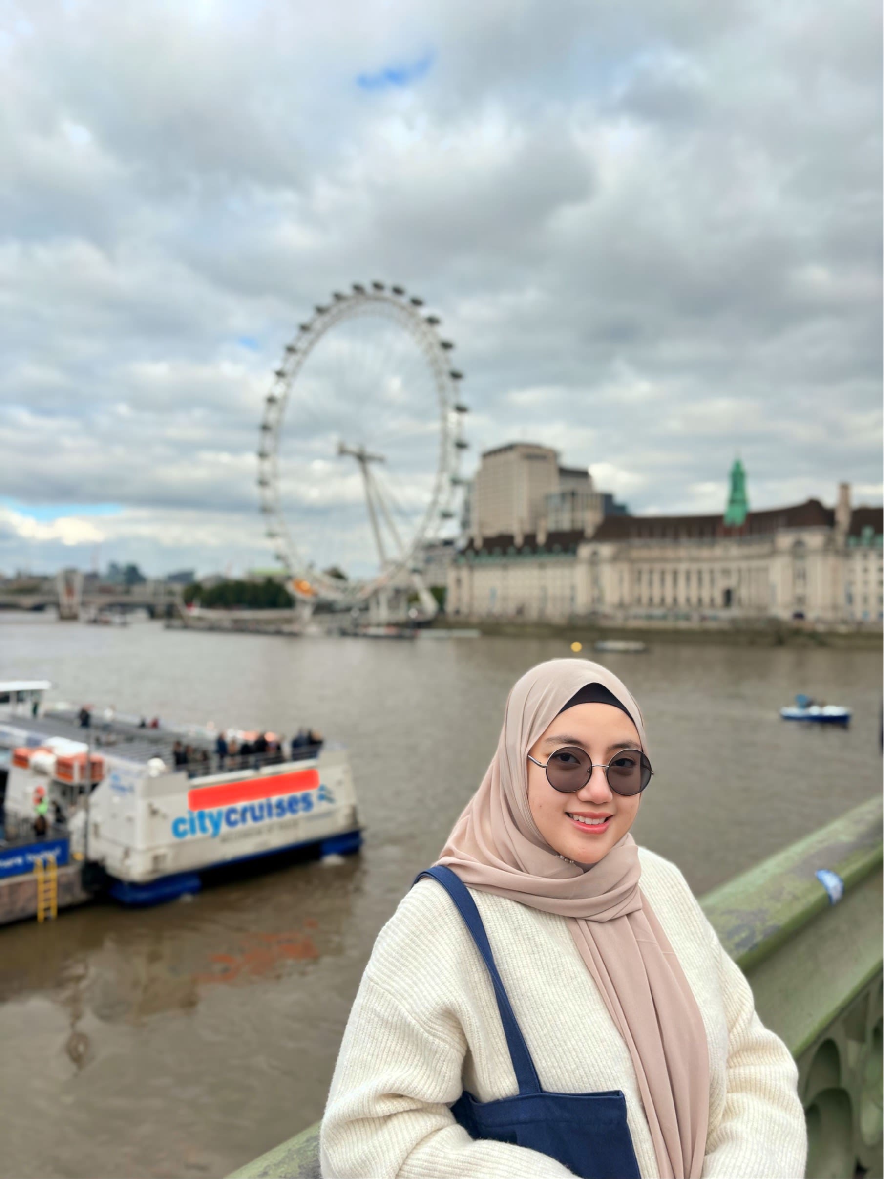 Nava standing in front of the London Eye