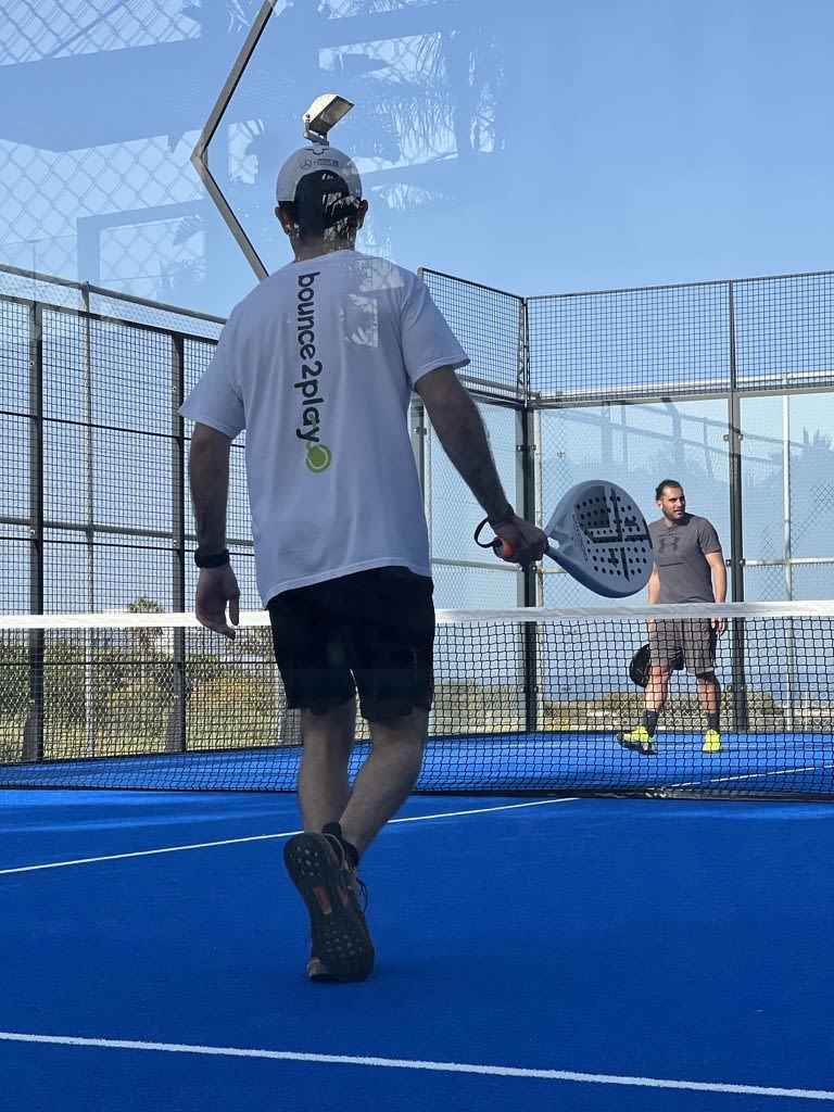 Neo playing padel.