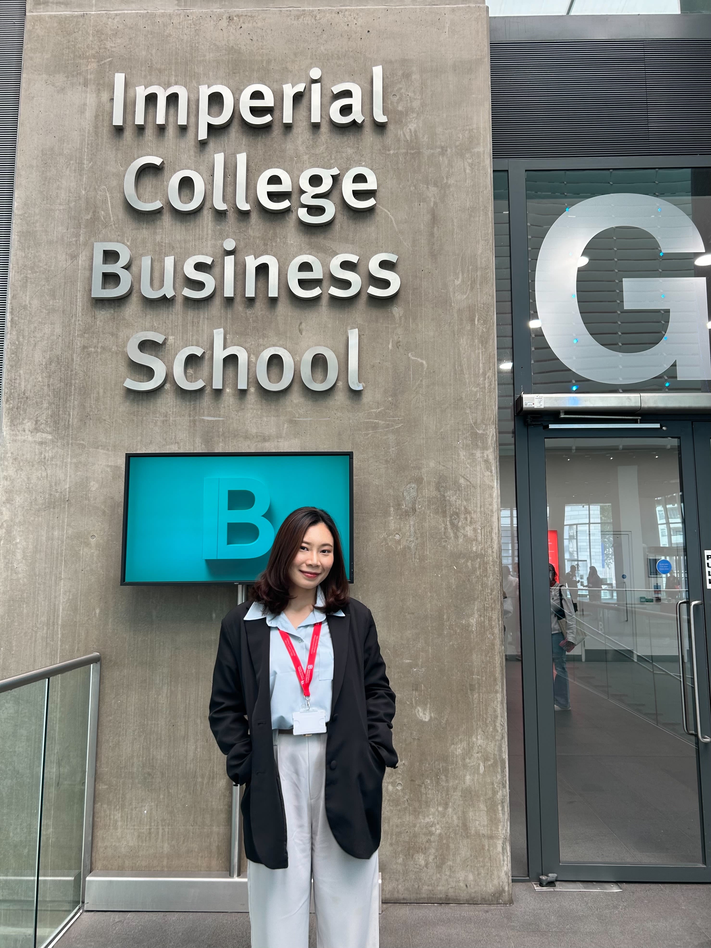 Rose standing underneath a big Imperial College Business School sign