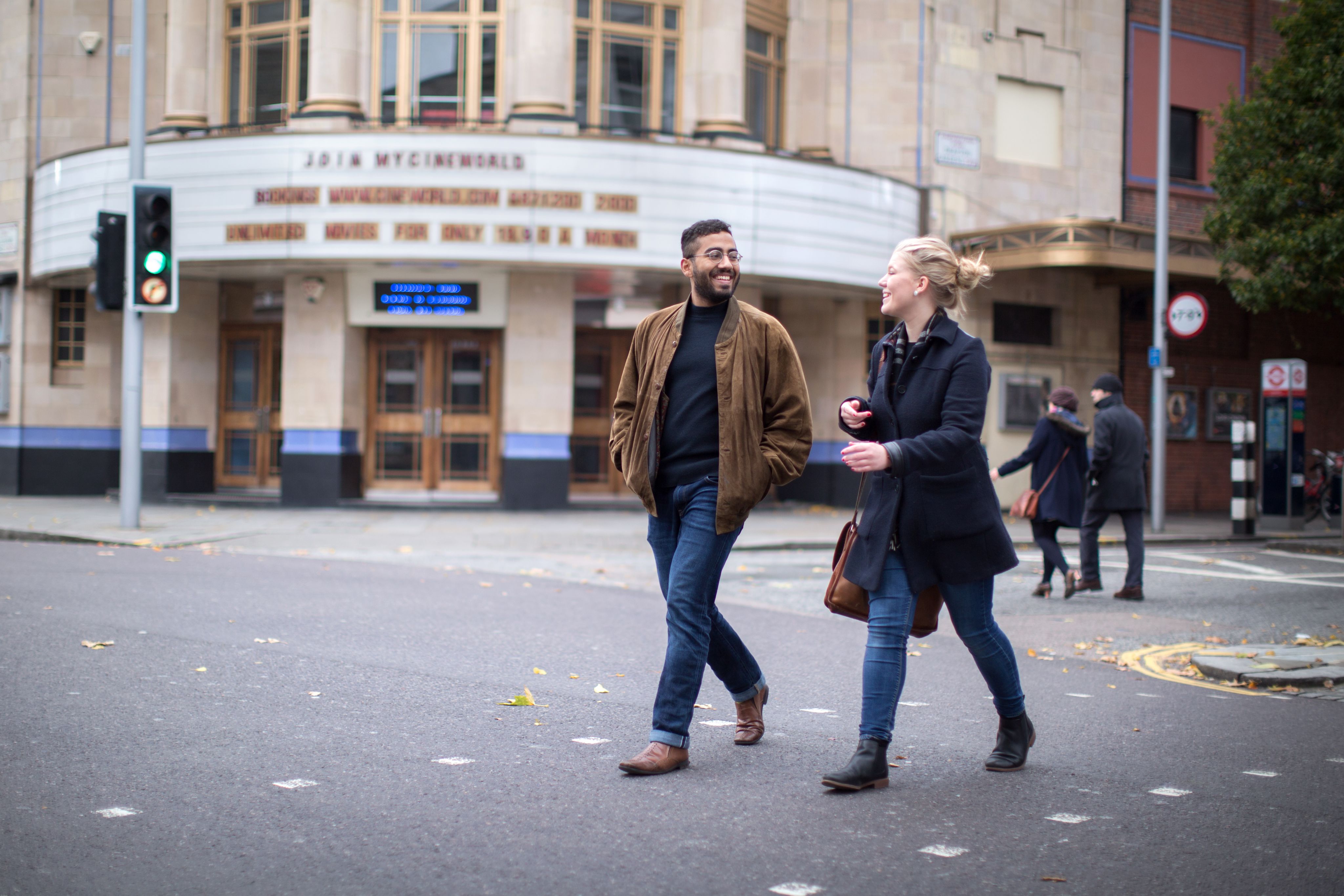 Two students walking and talking to each other in London
