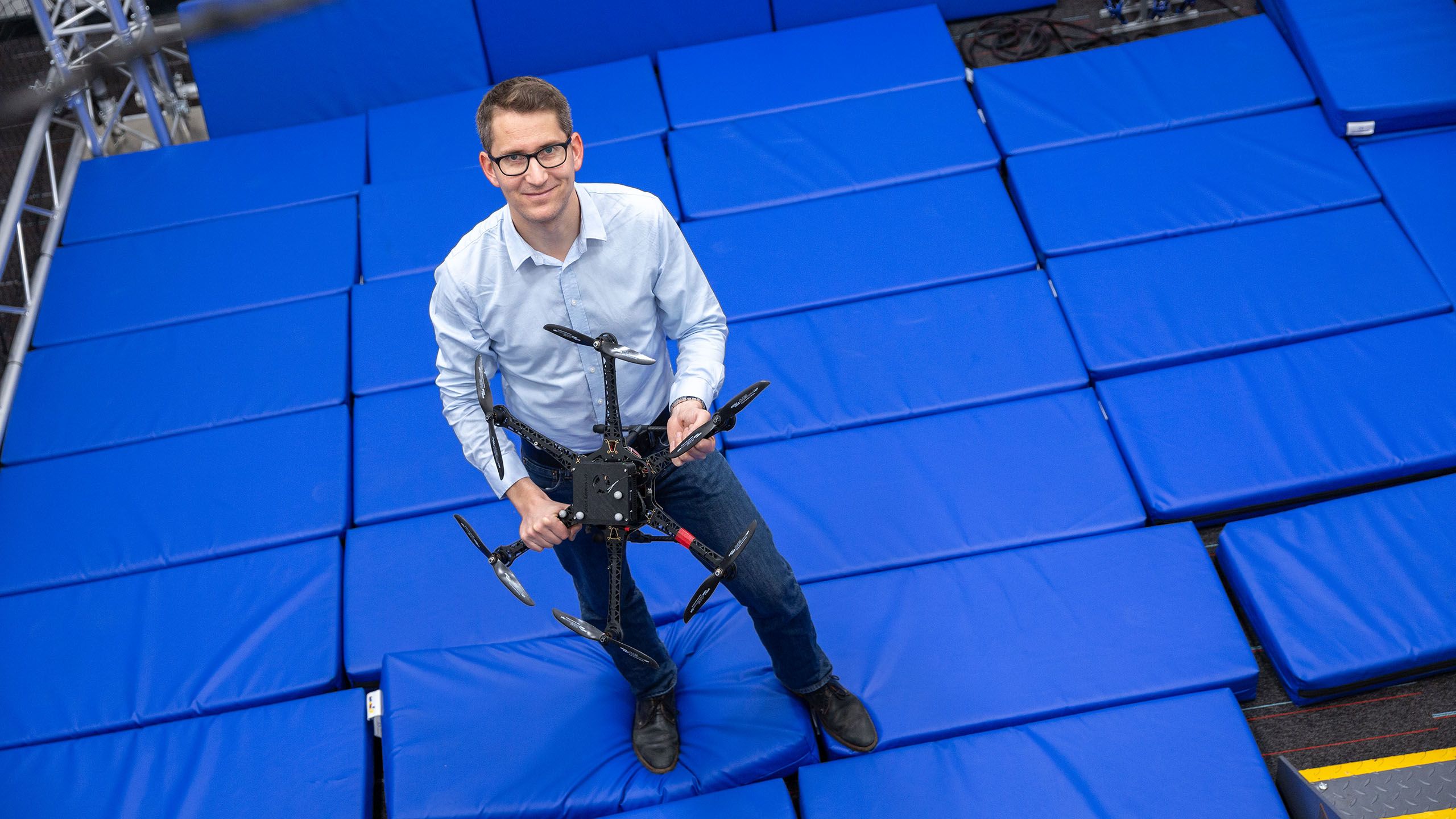 Dr Stefan Leutenegger with a drone in the Department of Computing's Robot Arena