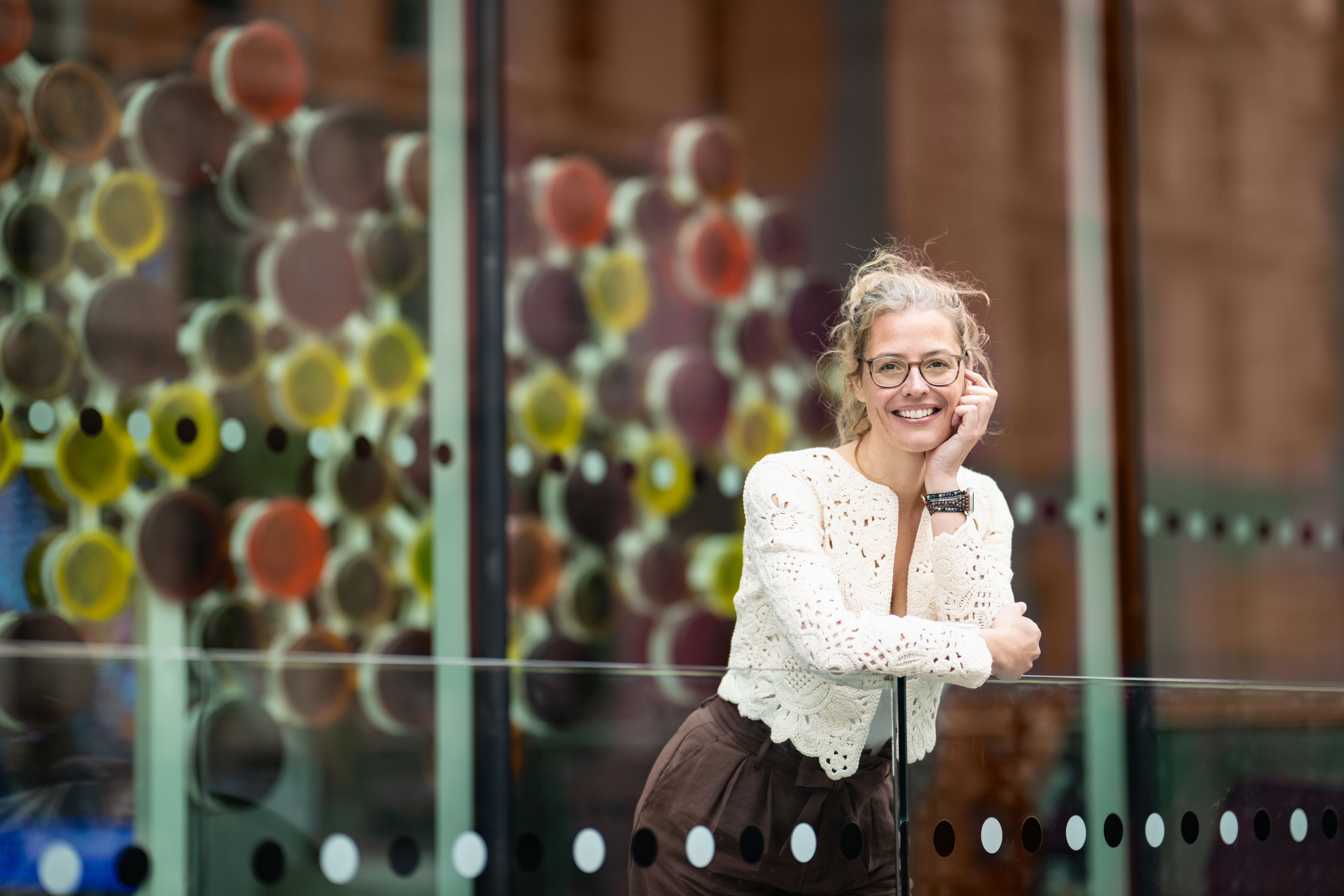 Sabine posing in front of a molecule art piece.