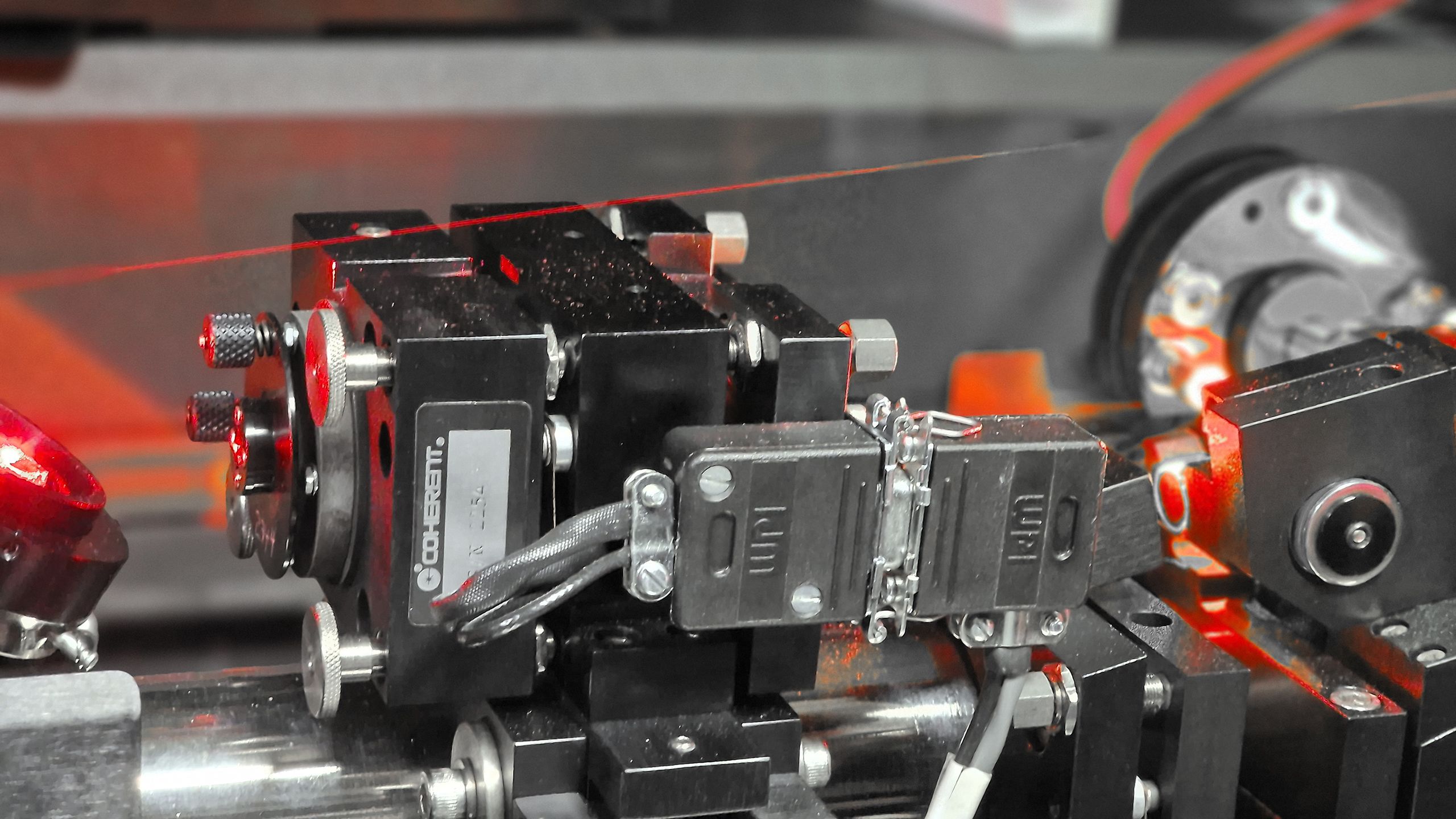 A close-up of lasers on an optical table