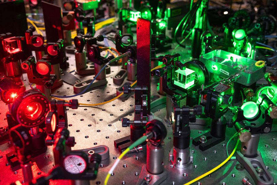 Mirrors and lenses bather in green and red laser light