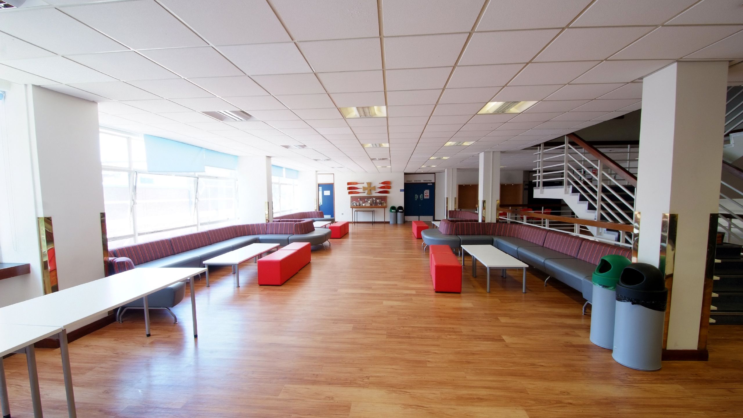 The Reynolds Building first floor concourse as it currently is, with a long bench and a few tables
