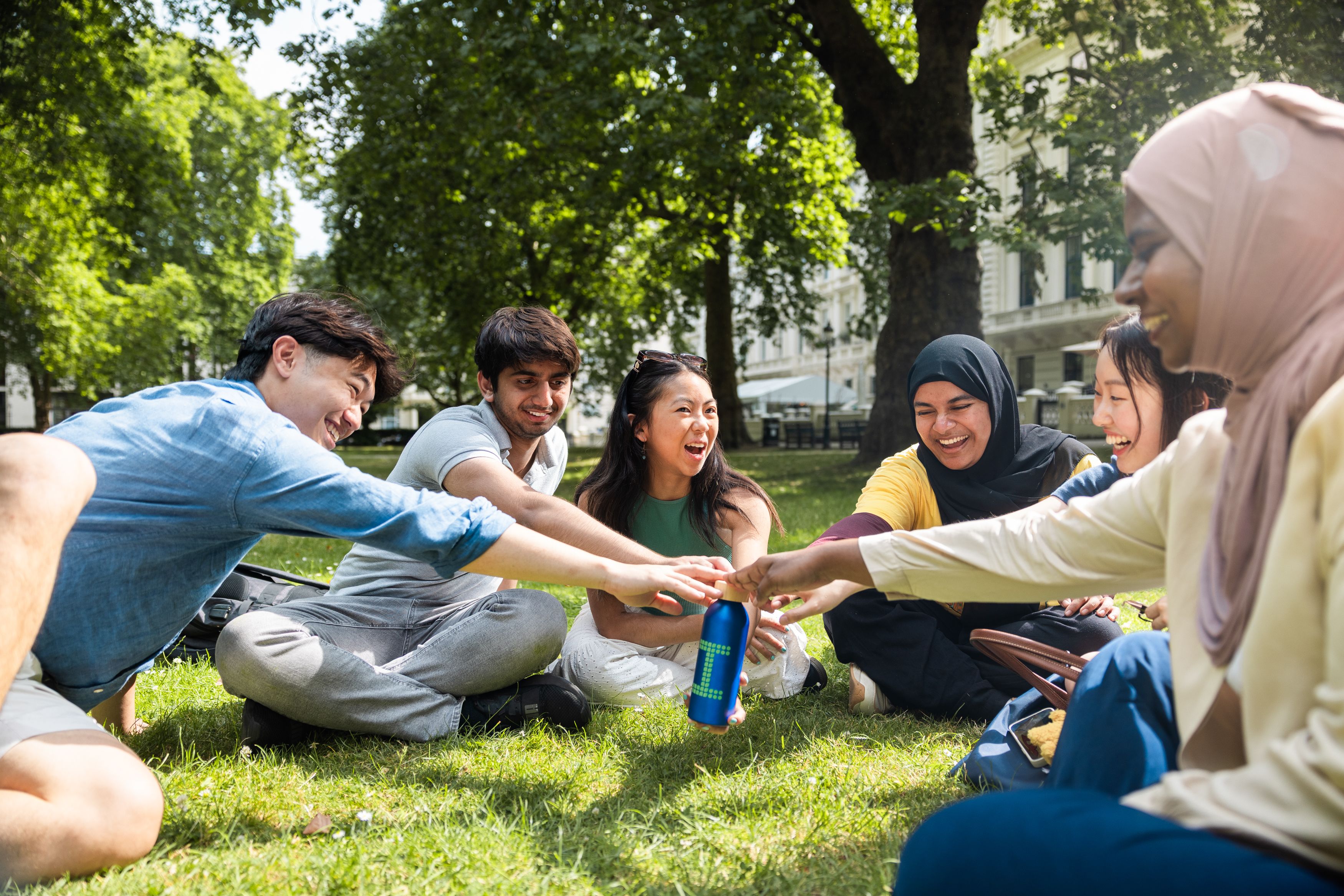 Students holding a sustainable Imperial water bottle