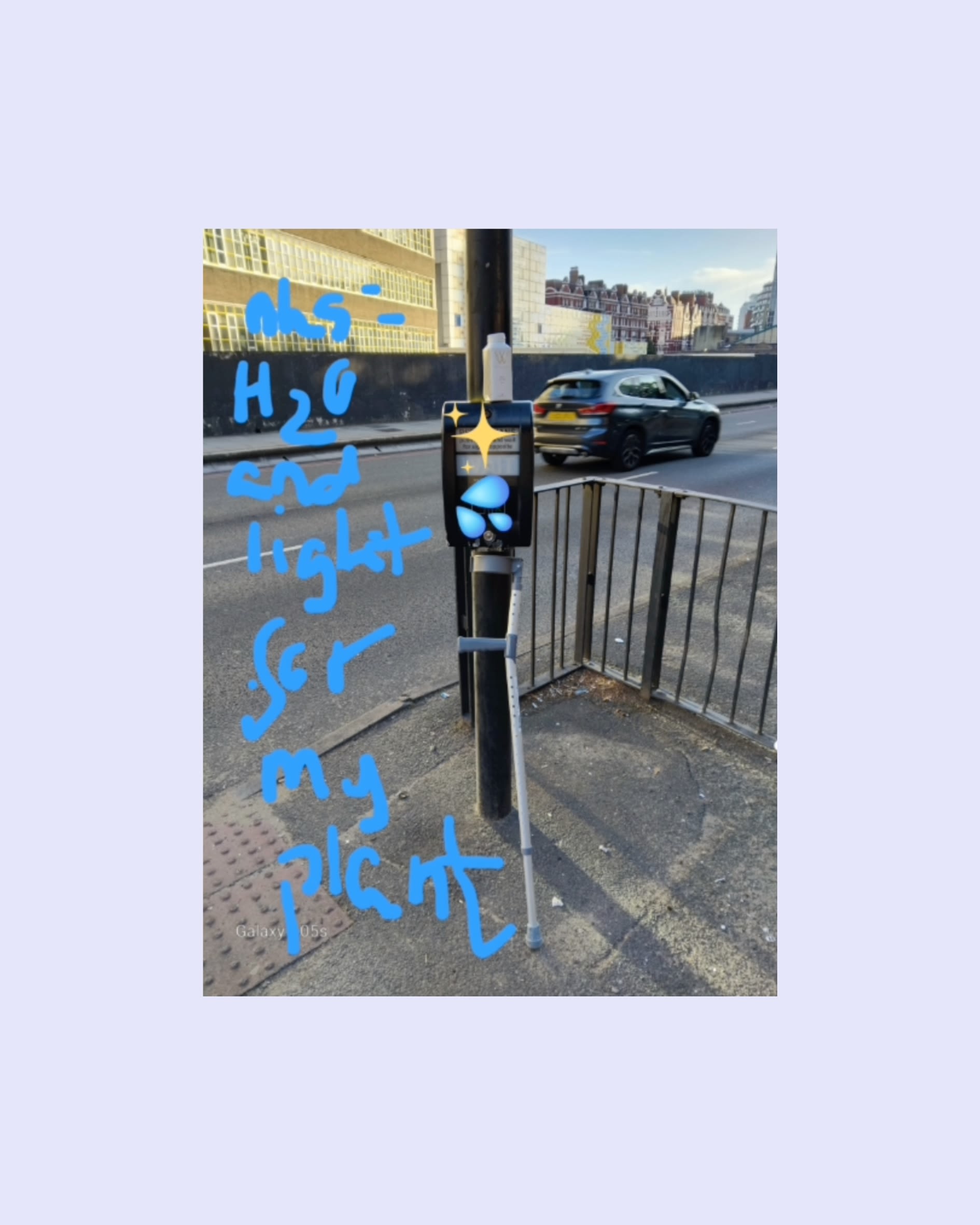 A cross walk button with a bottle of water on top of it and a crutch leant against it. The handwritten caption reads NHS: H2O and light for my plant.