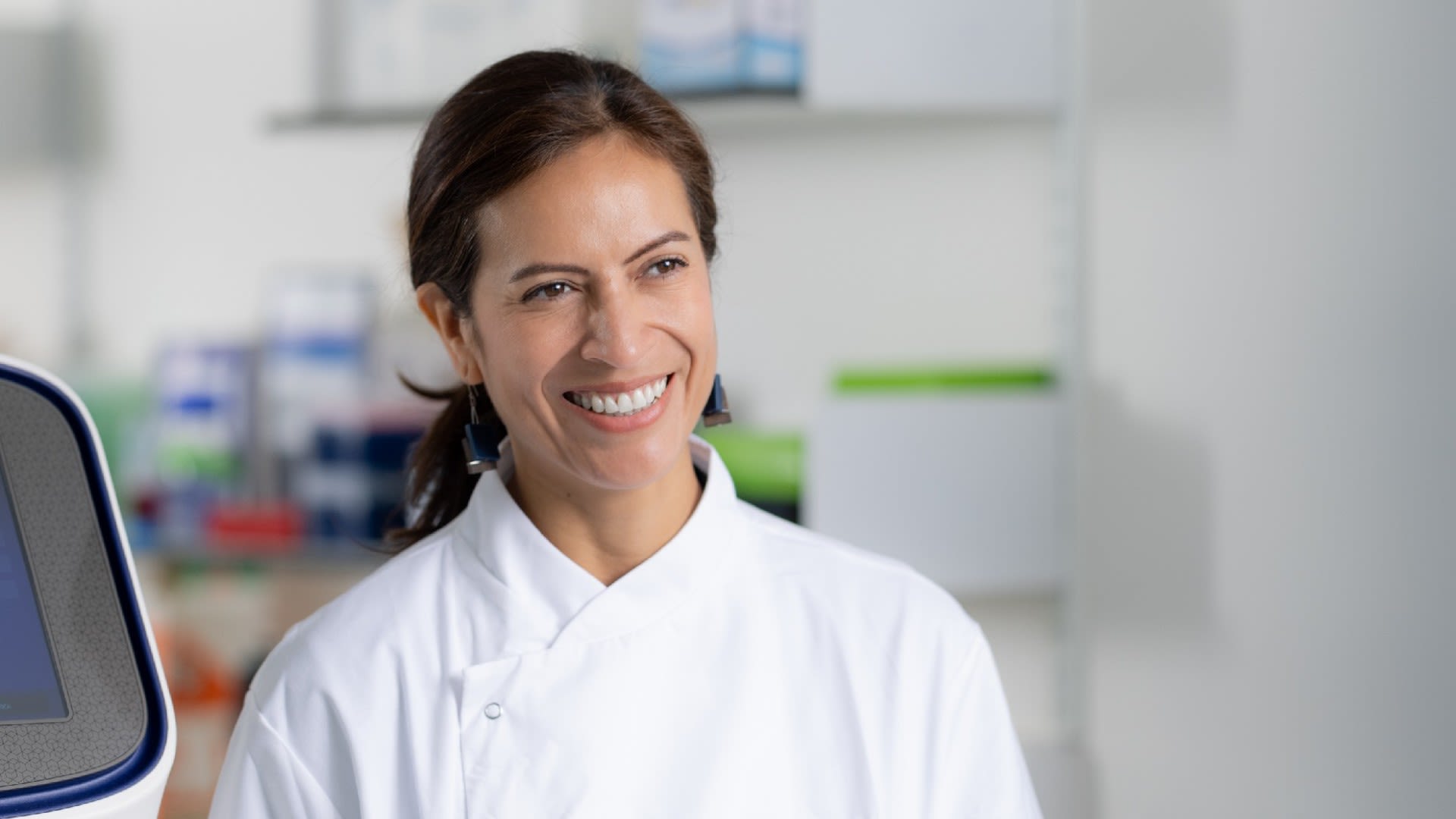 Paula in a lab coat smiling in a lab