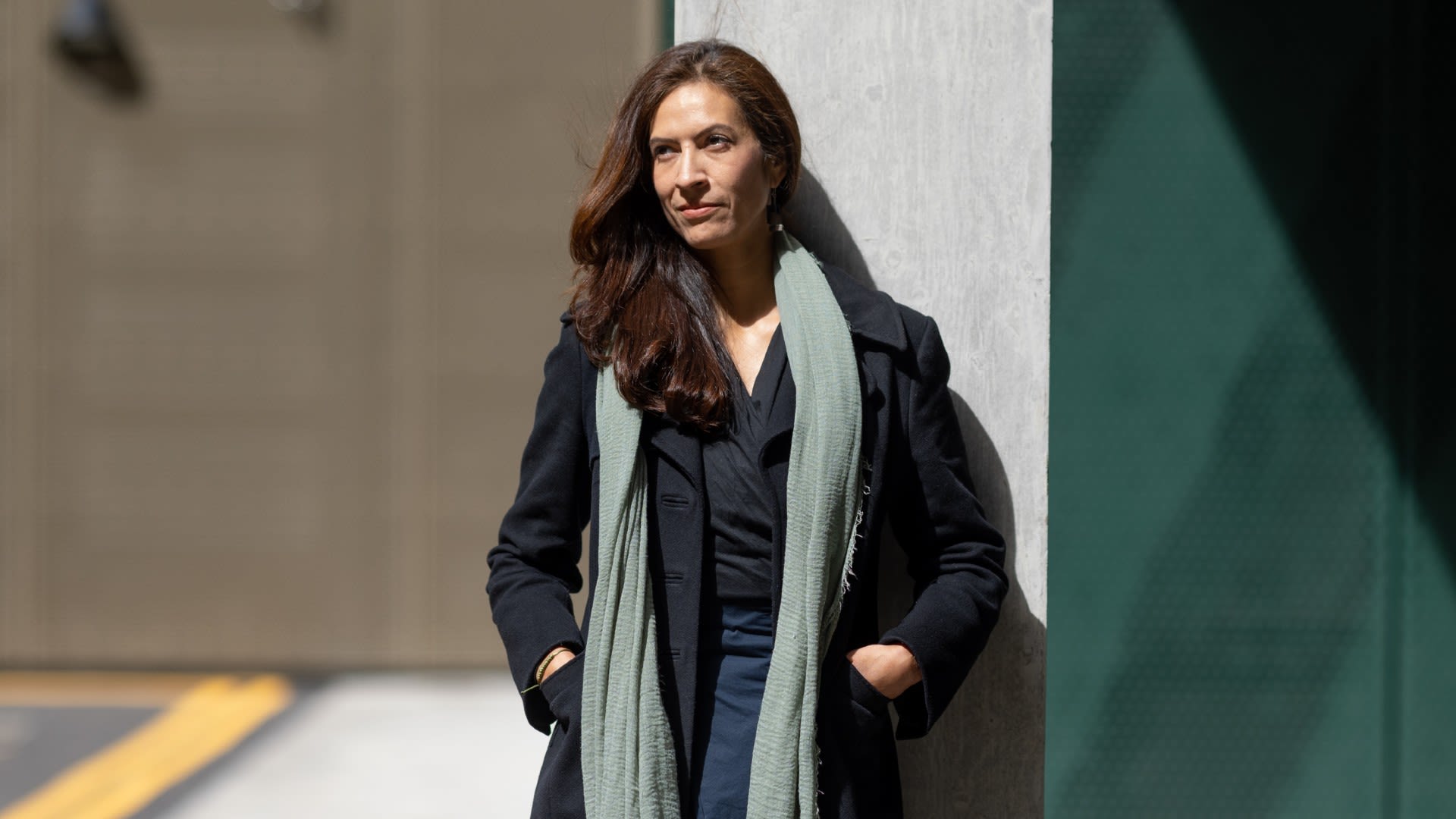 Paula leaning against a wall