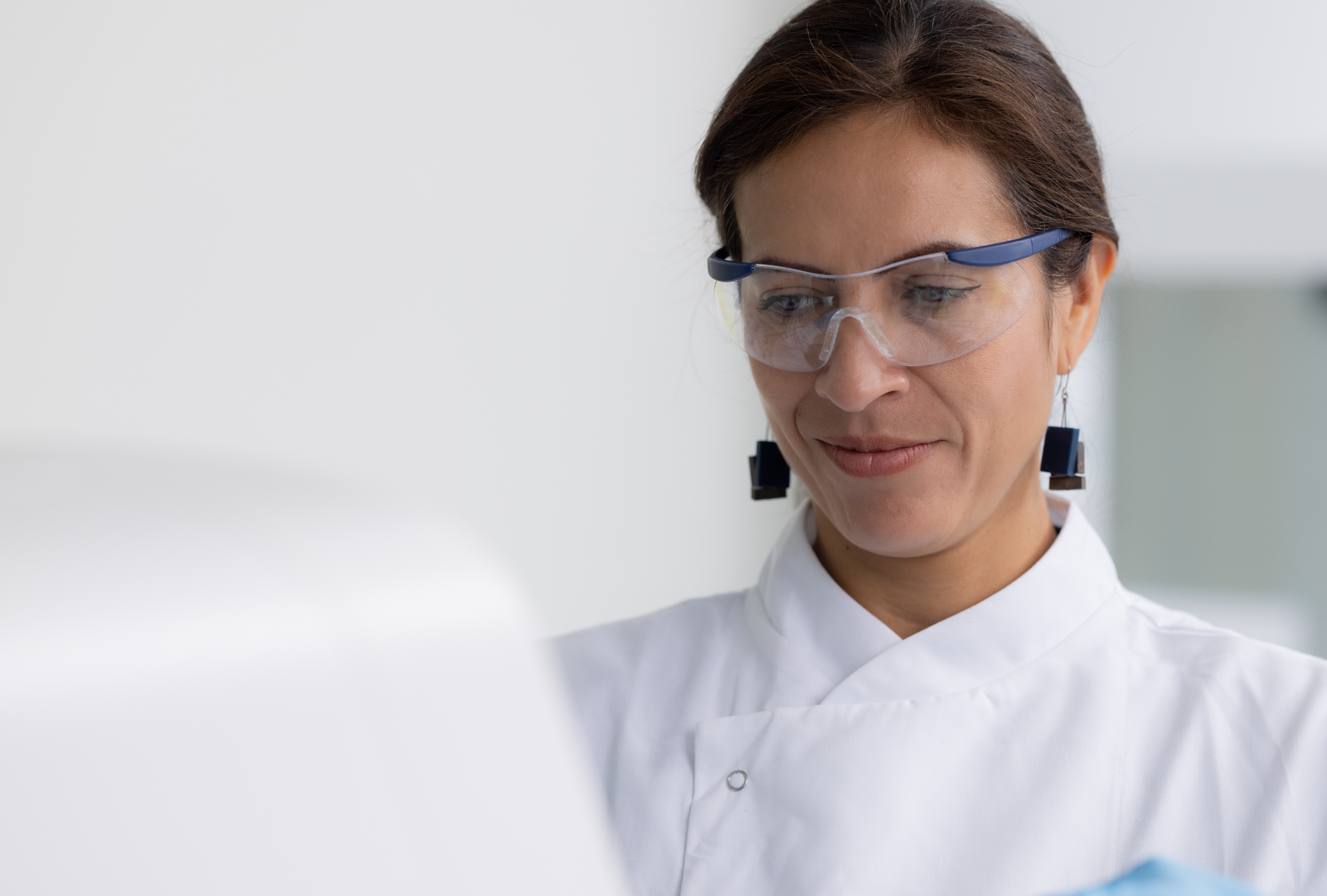 Paula in a lab coat and safety goggles