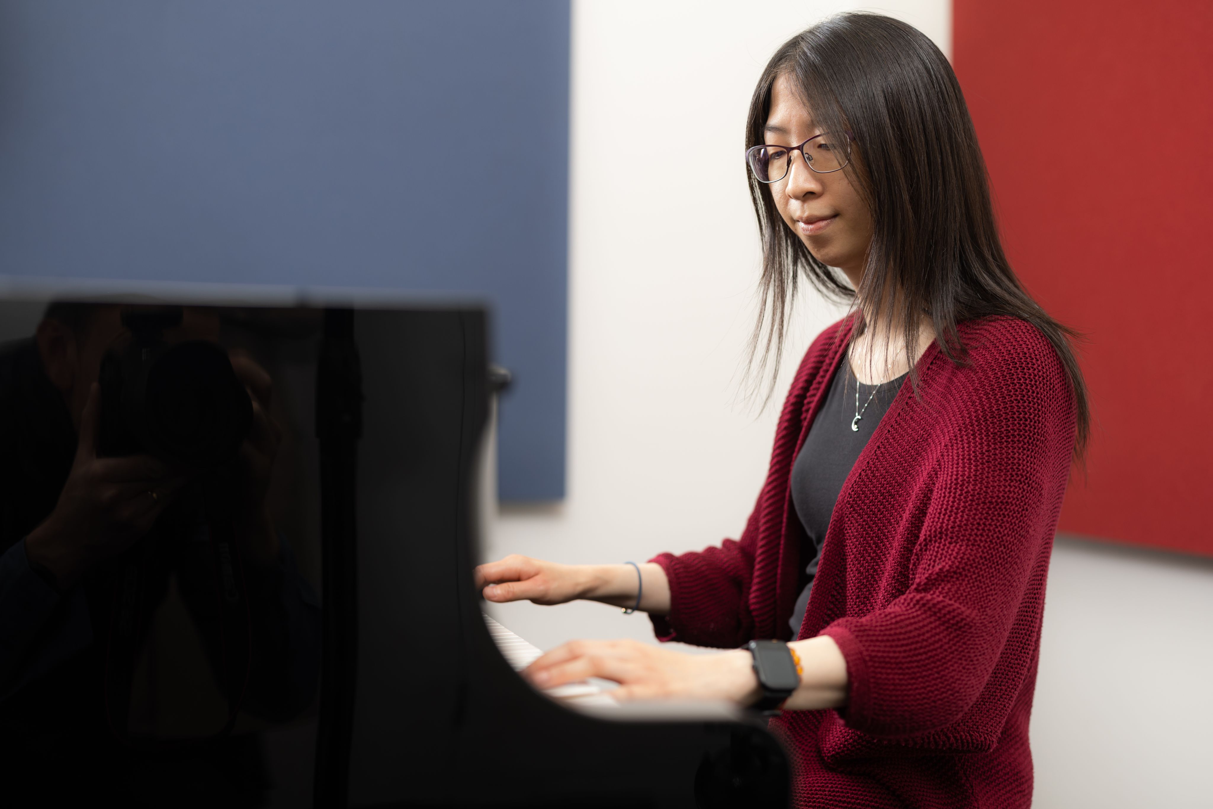Tiffany seated at a piano