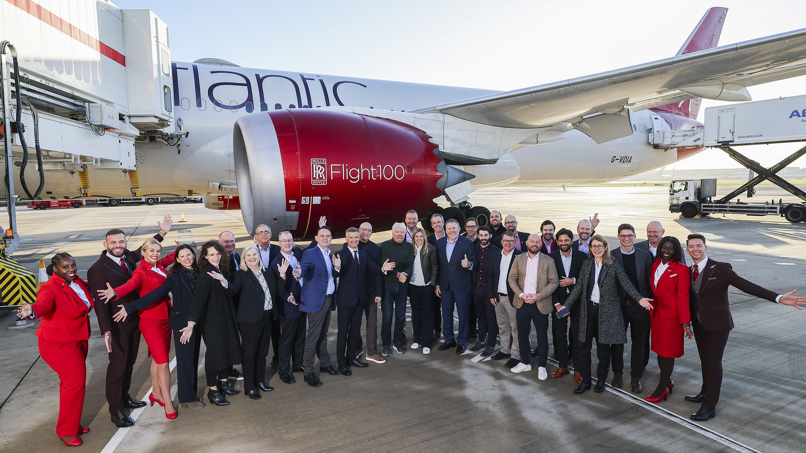 Large group of people in front of a Virgin Atlantic plane