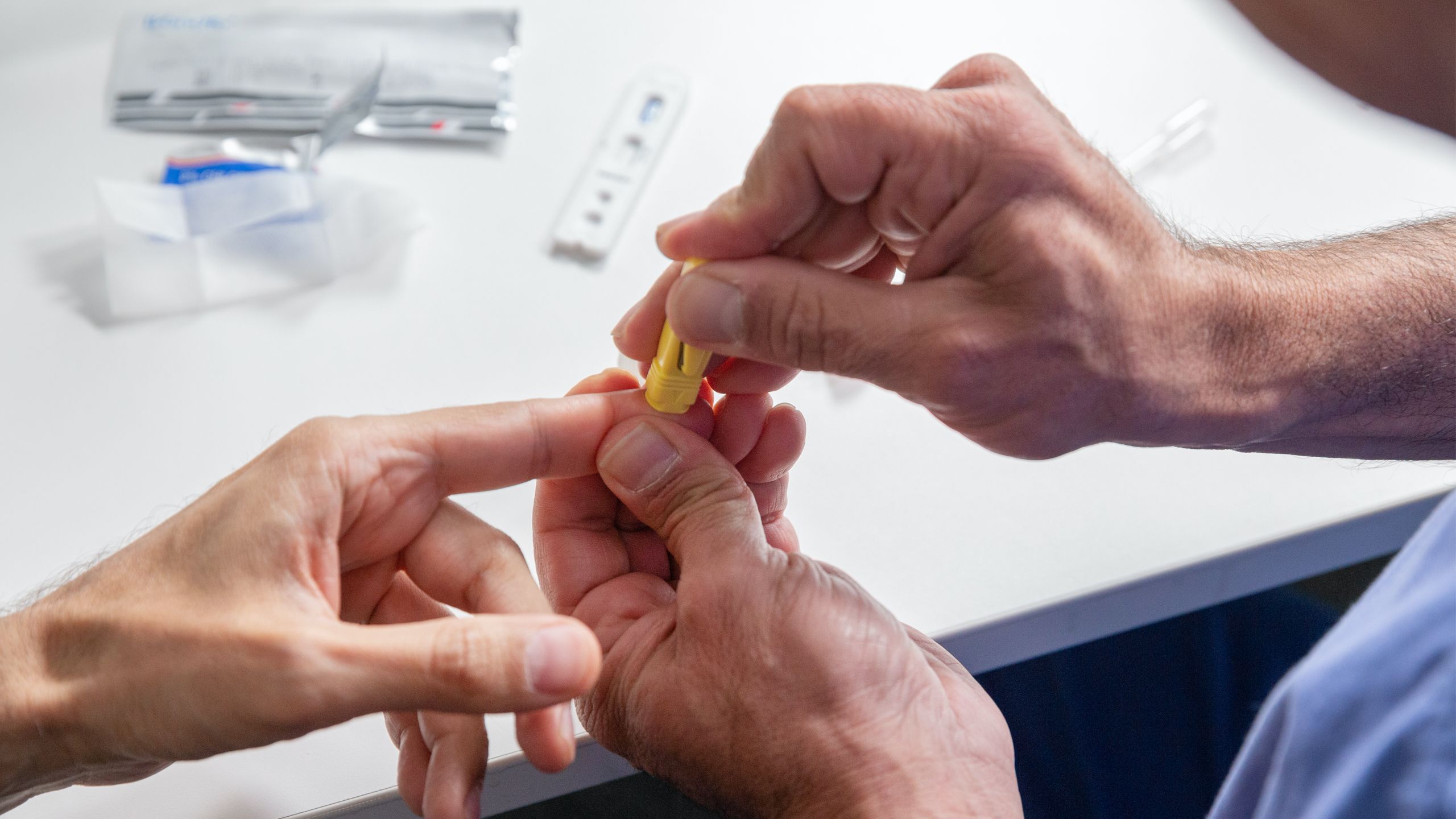 Person using finger-prick device