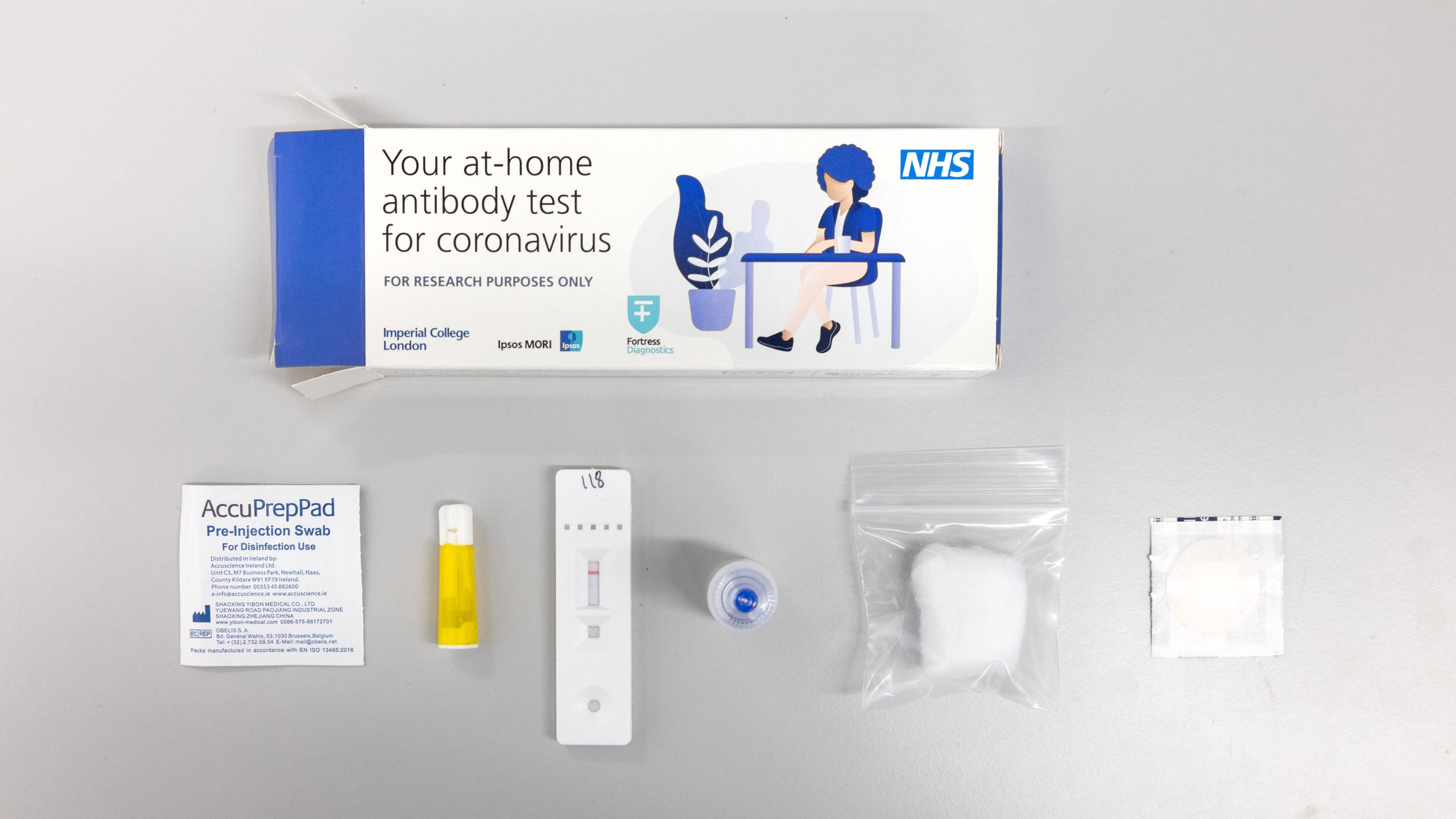 A COVID-19 antibody testing kit laid out on a bench