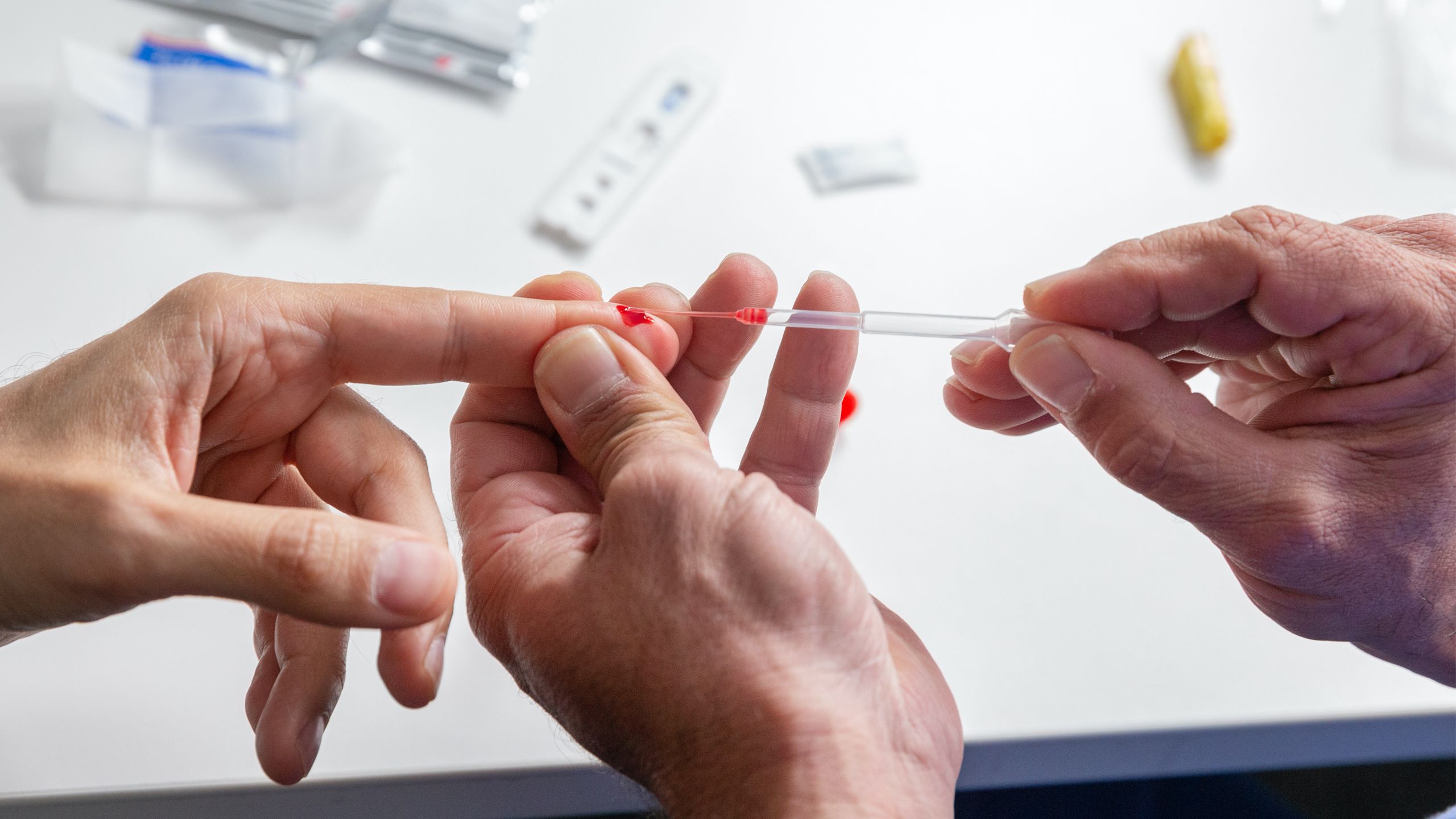 Finger prick of blood being drawn for an antibody test