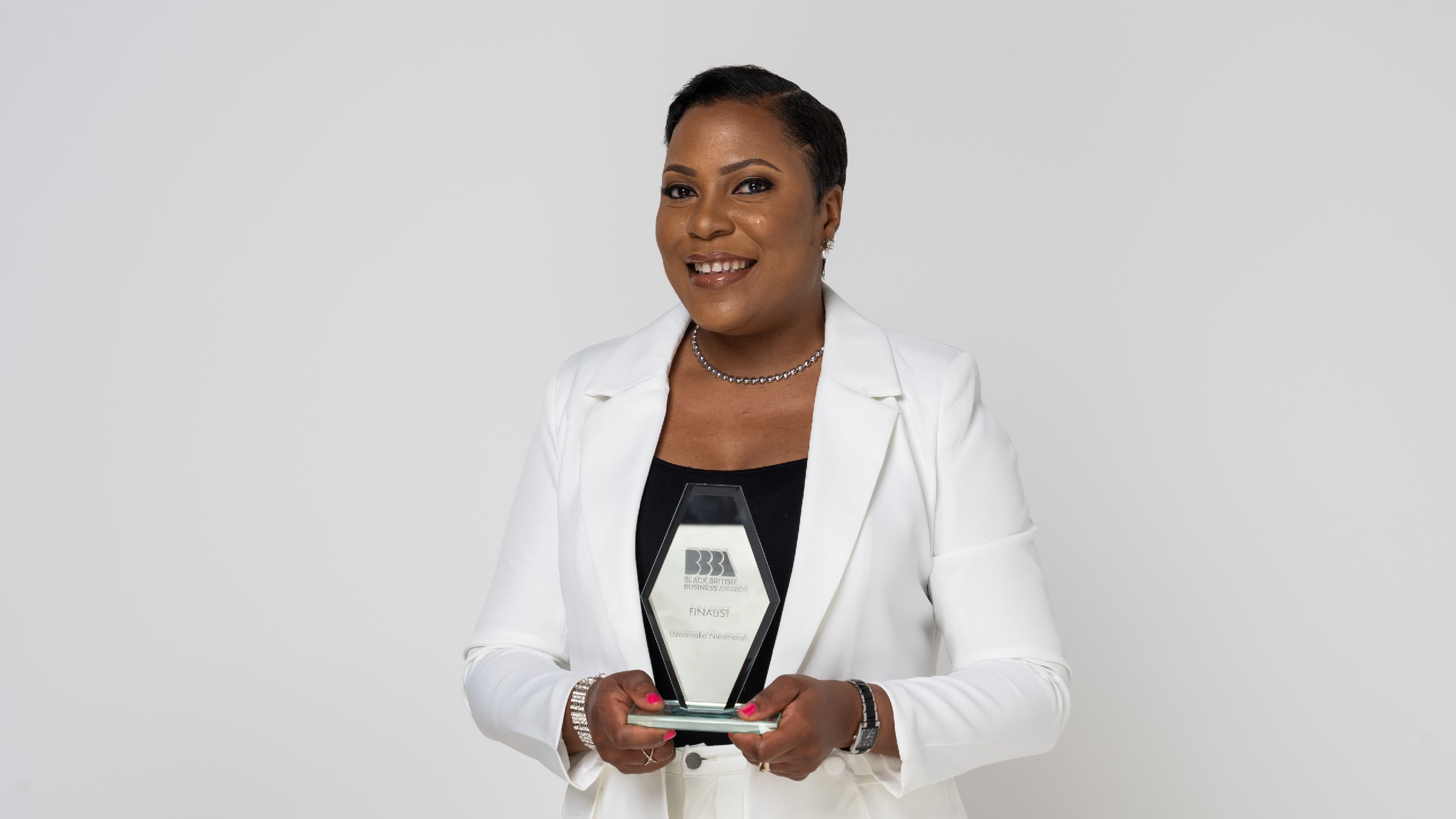 Uzo holding an award