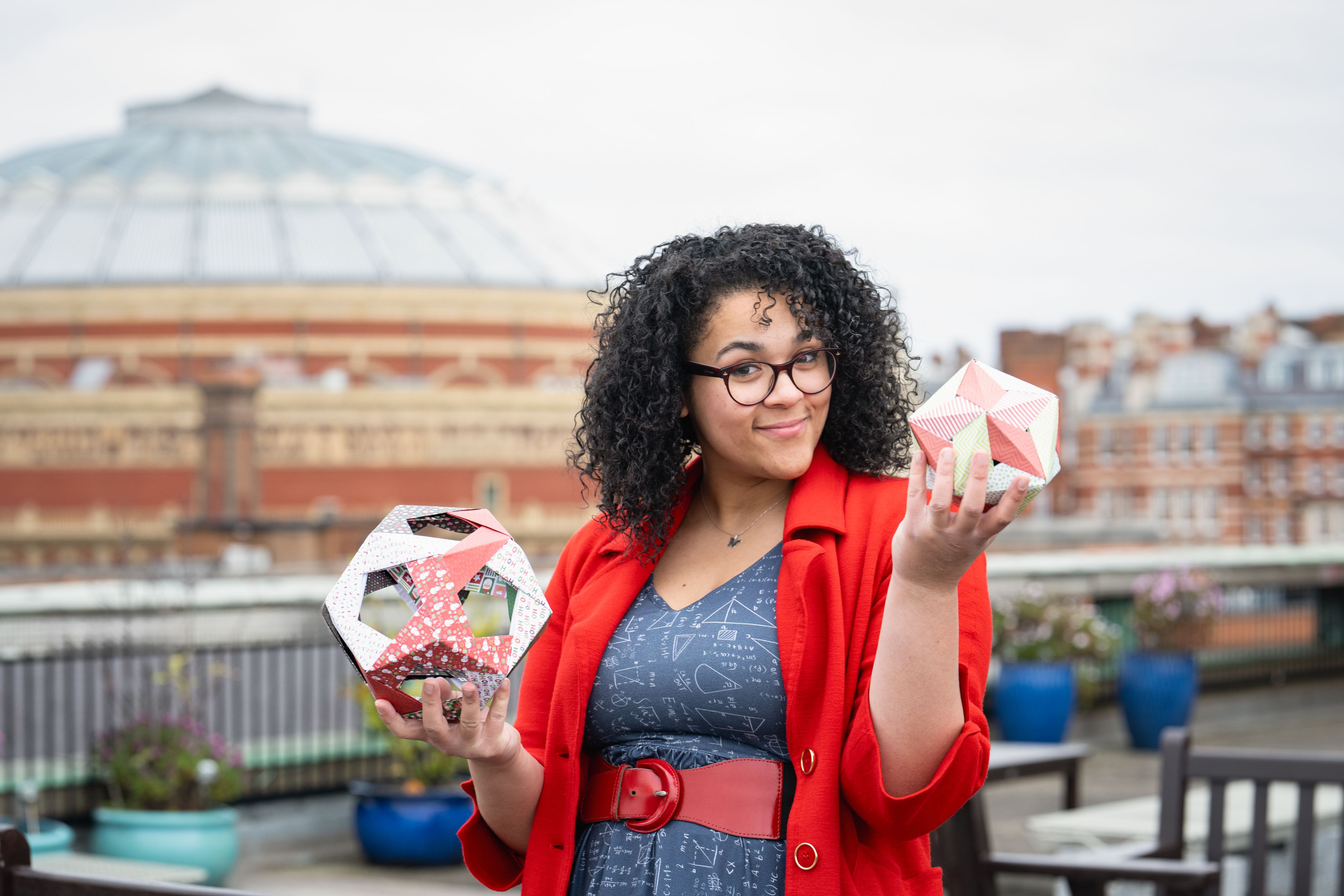 Vanessa holding geometric shapes with the Royal Albert Hall in the background.