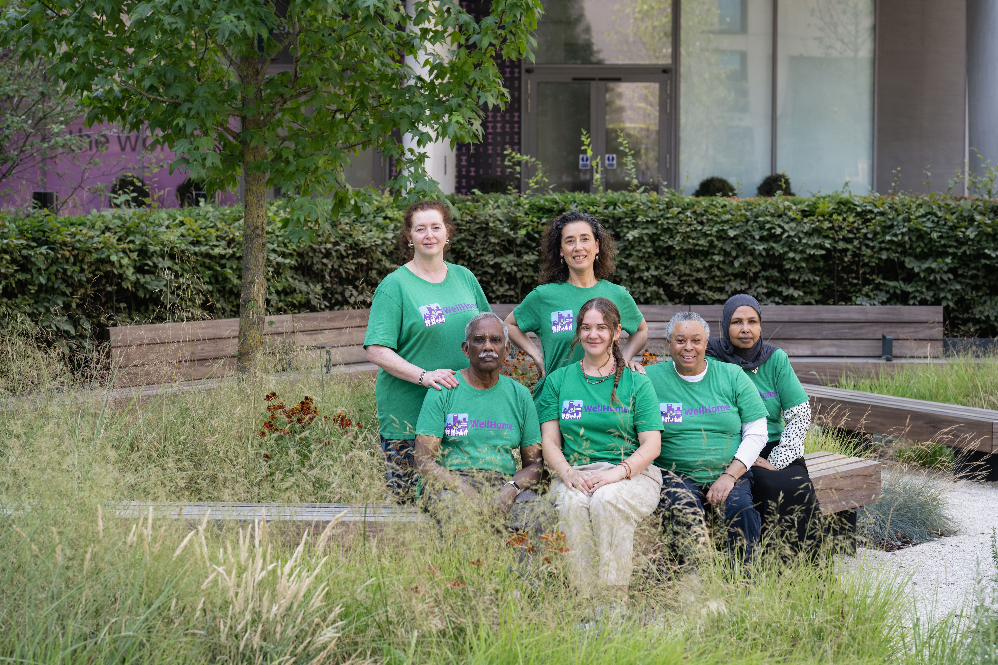 The Ambassadors sitting in a group on an outdoor bench.