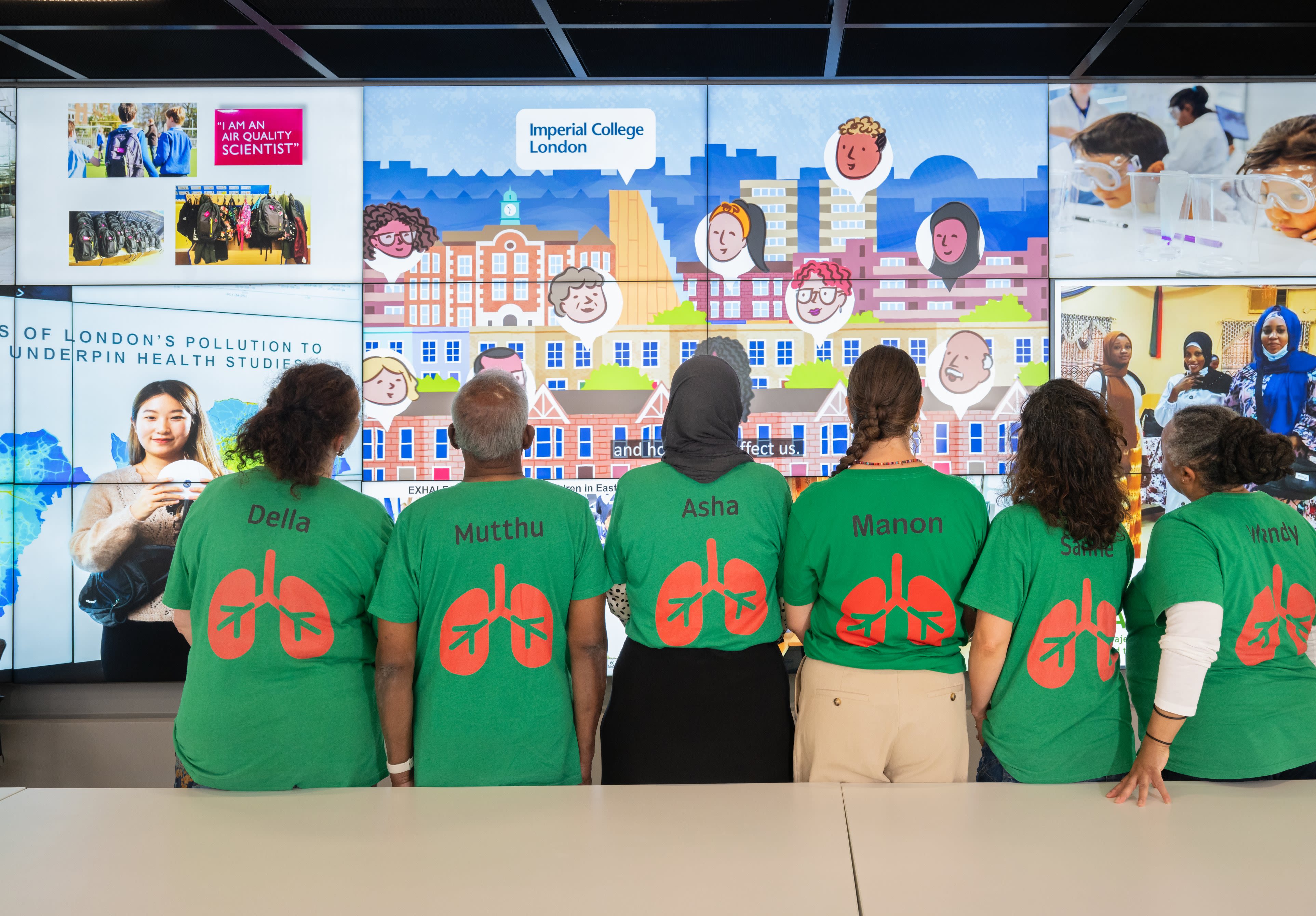 The full group of Ambassadors with their backs to the camera showing off the back of their branded t-shirts, which display their names and a cartoon lung.