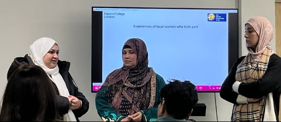 3 ladies in headscarves that are members of the Mosaic Community Trust, giving a talk.