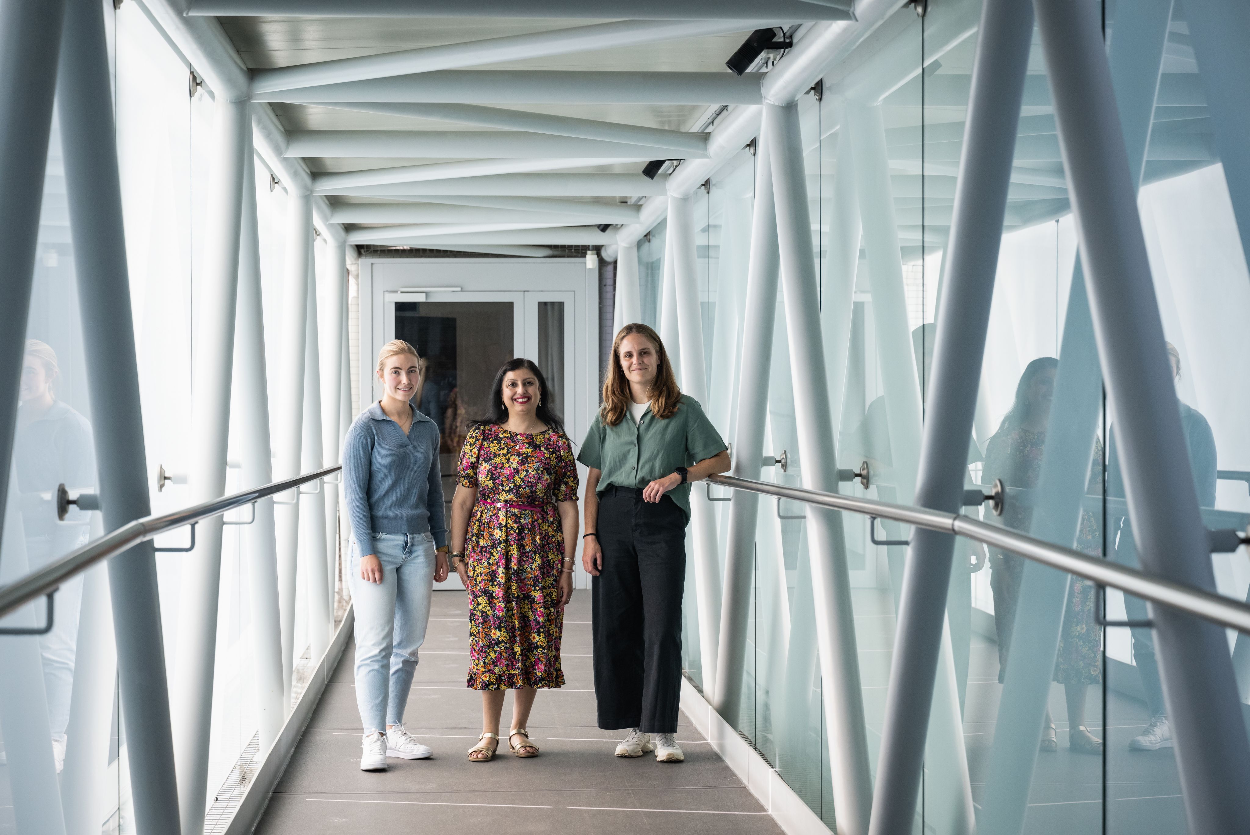 Rakhee, Jenny and Ellen standing smiling on a bridge