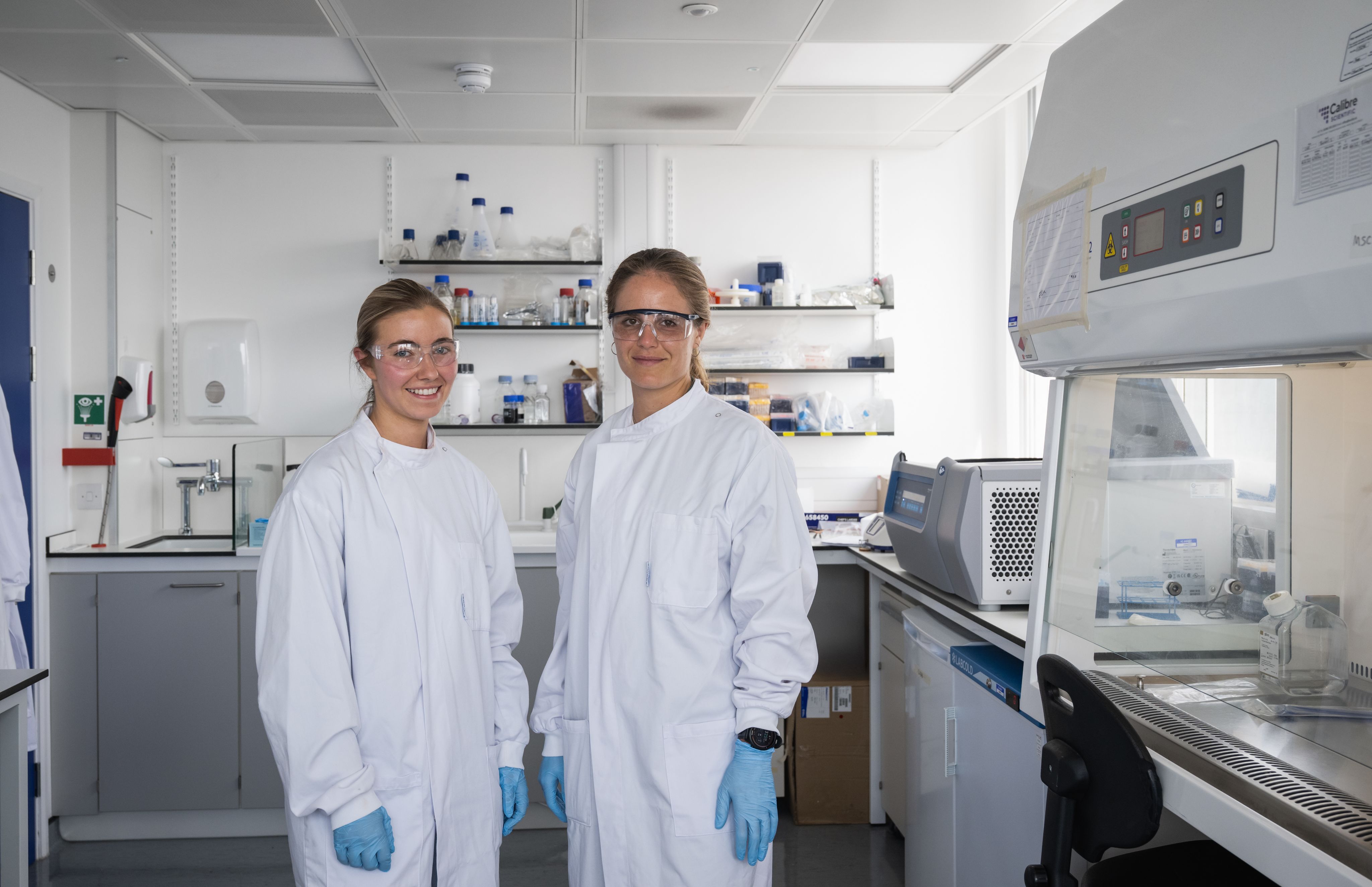 Jenny and Ellen standing in their lab